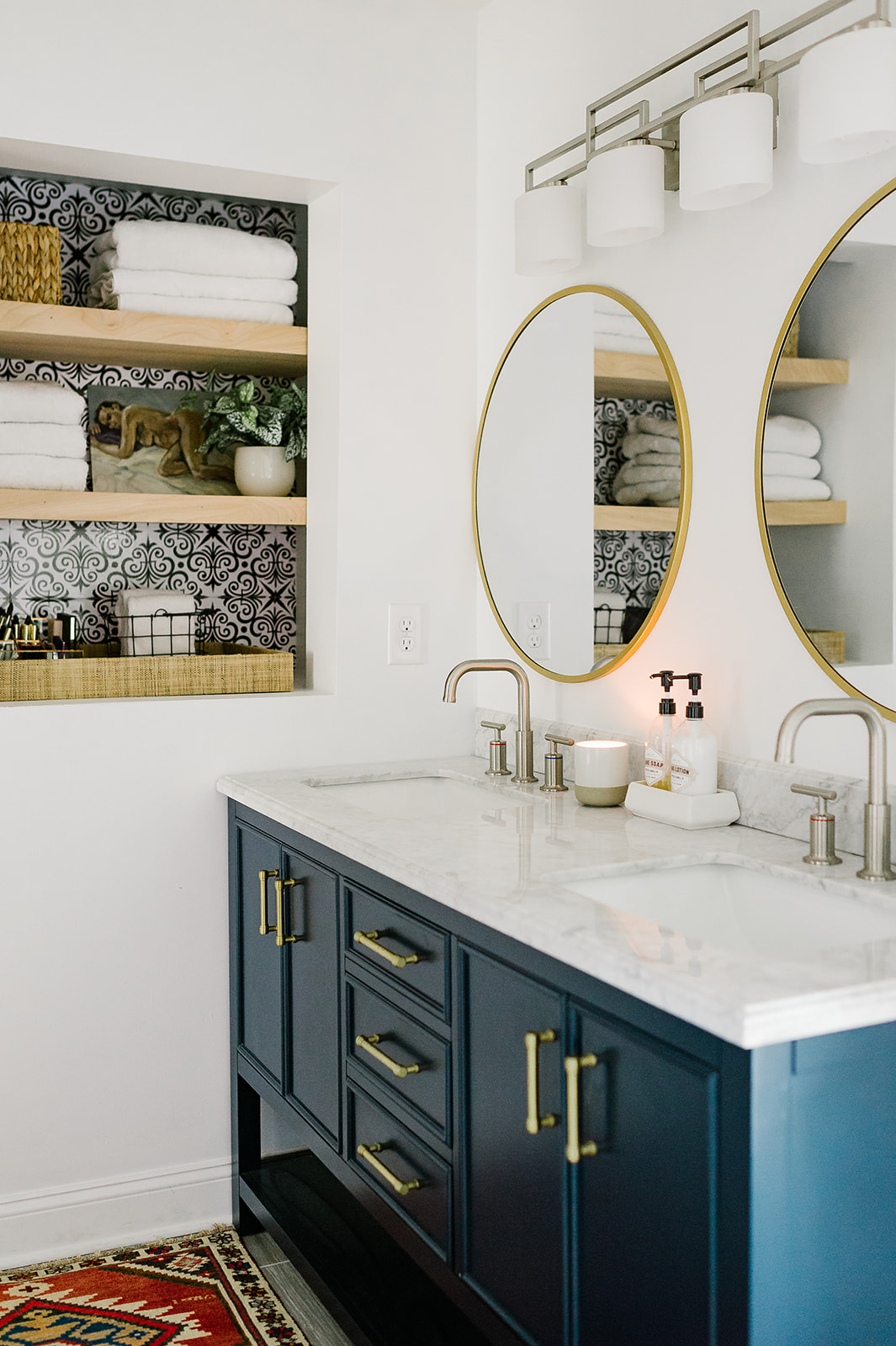 Between the Studs open shelves with bleu and white mosaic tile on the back.