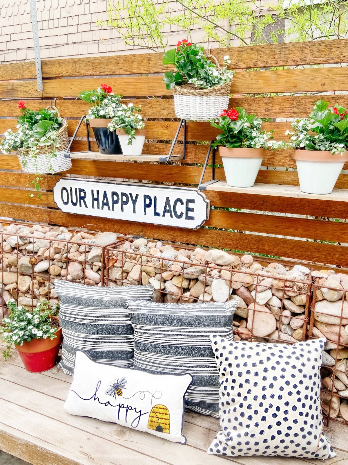 https://tatertotsandjello.com/wp-content/uploads/2021/04/bee-patio-with-pillow-and-hanging-baskets.jpg