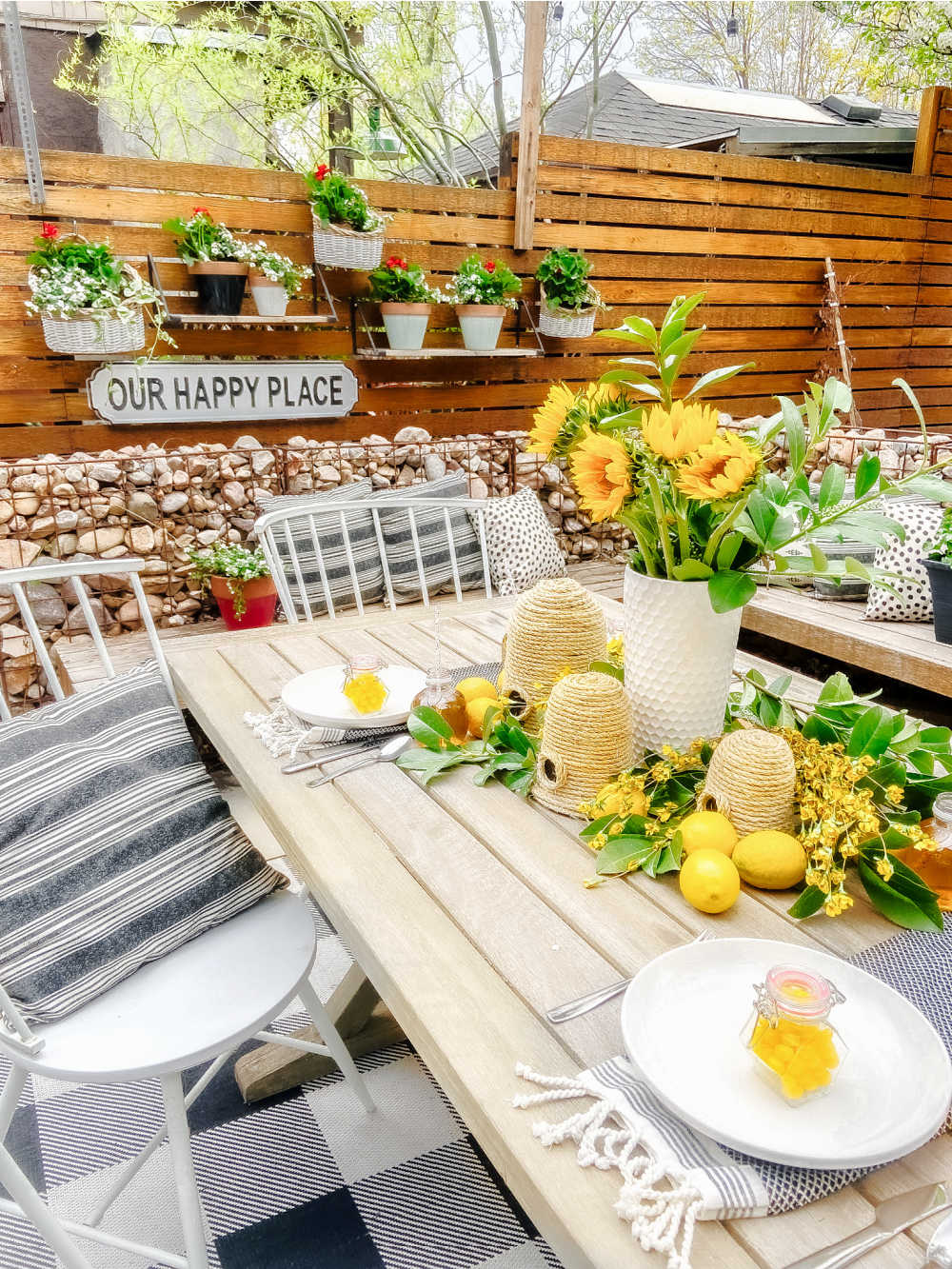 DIY Beehives and Beehive Backyard Inspo! Create cute and inexpensive beehives, add beehive pillows and create a hanging basket garden for a beautiful summer patio!