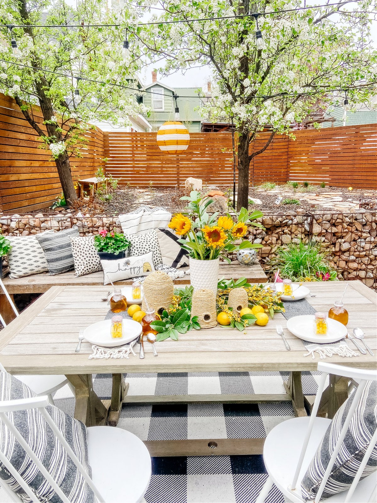 DIY Beehives and Beehive Backyard Inspo! Create cute and inexpensive beehives, add beehive pillows and create a hanging basket garden for a beautiful summer patio!