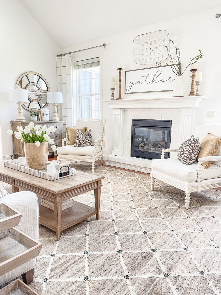 traditional wood and white living room with gather sign on mantel.