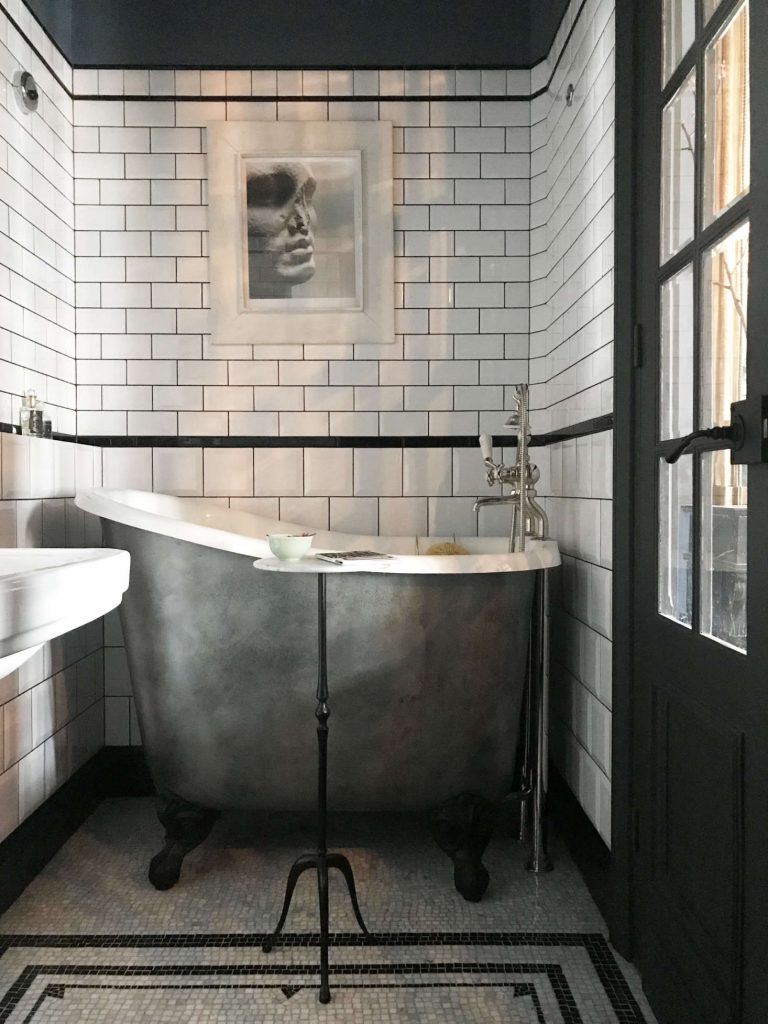 A very small and deep clawfoot tub in an english bathroom remodel.