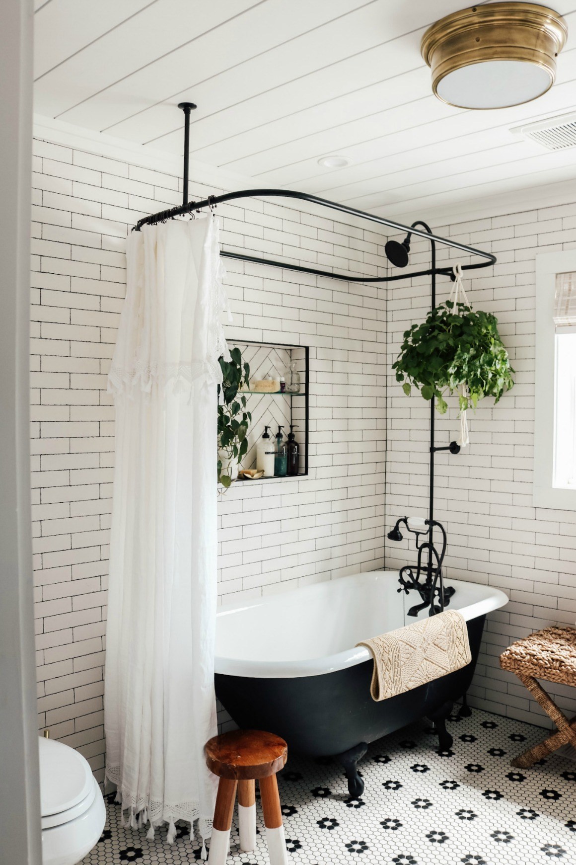 Master bathroom remodel at Nesting with Grace using a black clawfoot tub and classix hex tile. 