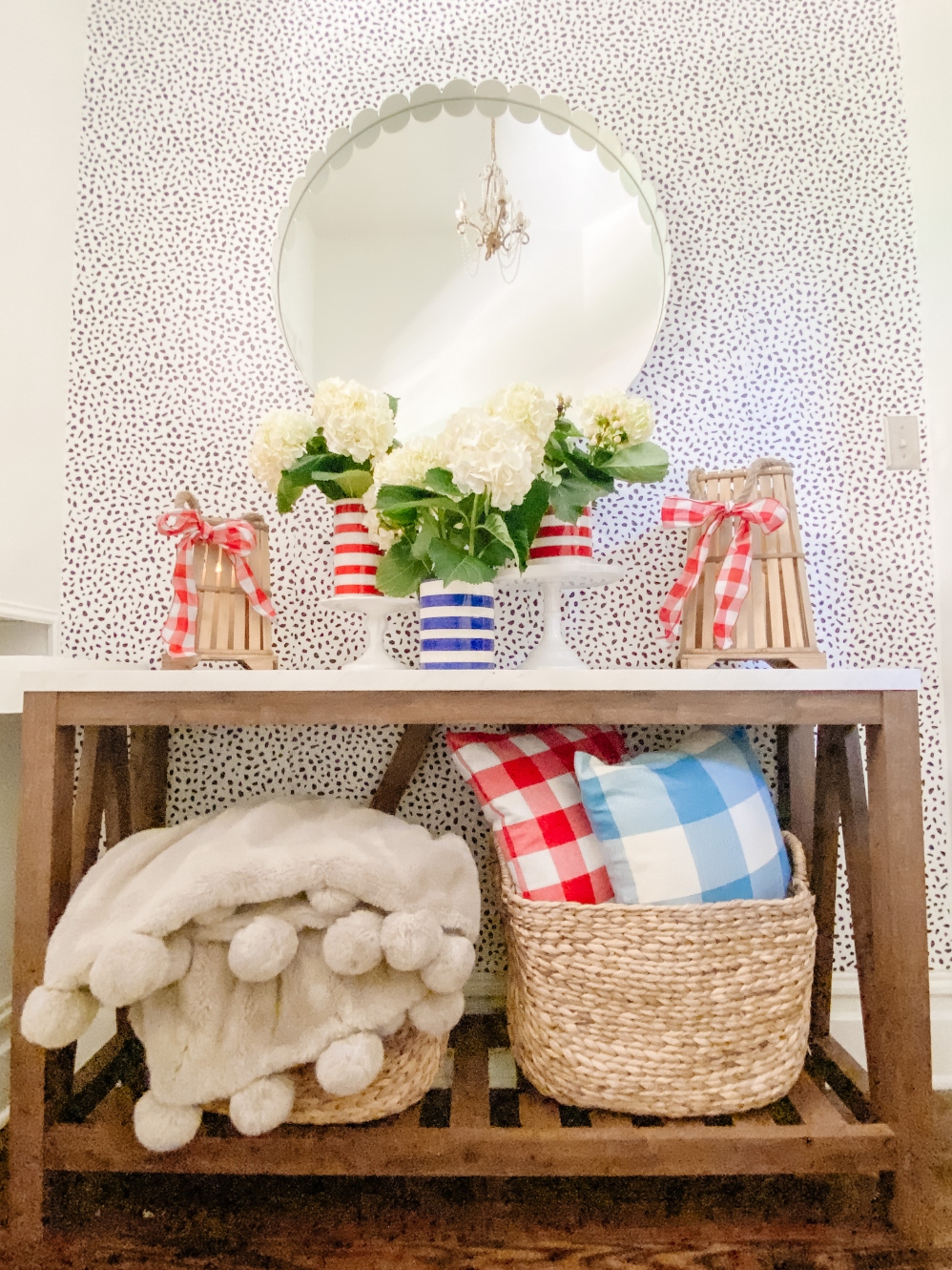 Summer Patriotic Entryway Table Decorating with gingham pillows and blue and red striped vases with hydrangeas. 