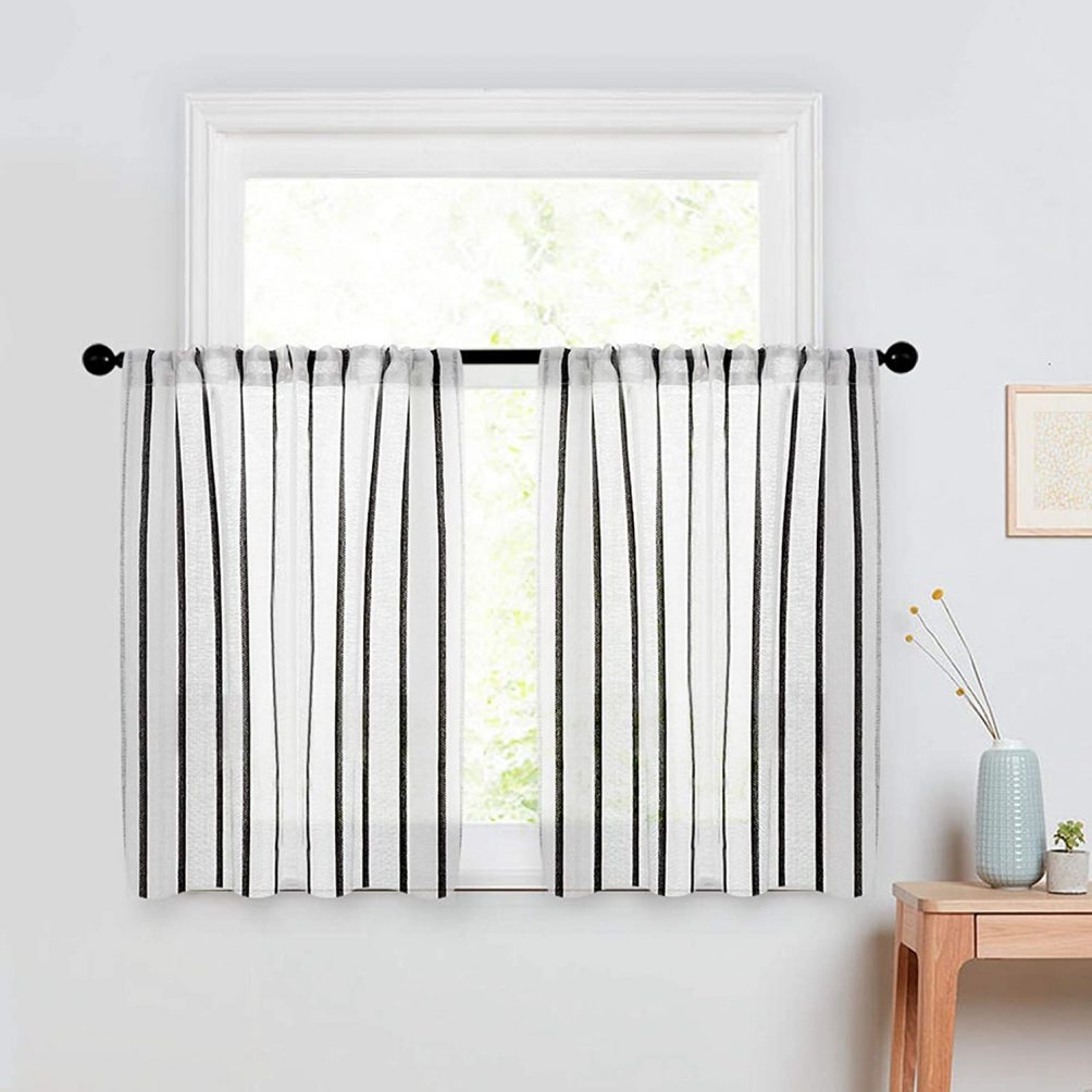 Black and White cafe curtains that are the perfect material so sun comes in but people can't see inside when closed.