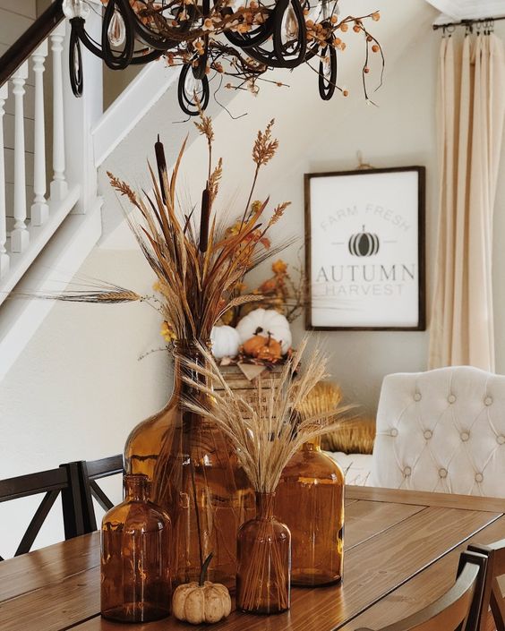 Amber bottles with grasses on a table at Have Need Want.