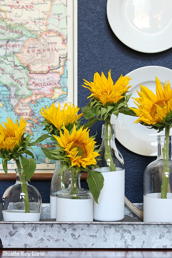 Sunflowers displayed in dipped white vases on a tray from Thistle Key Lane blog. 