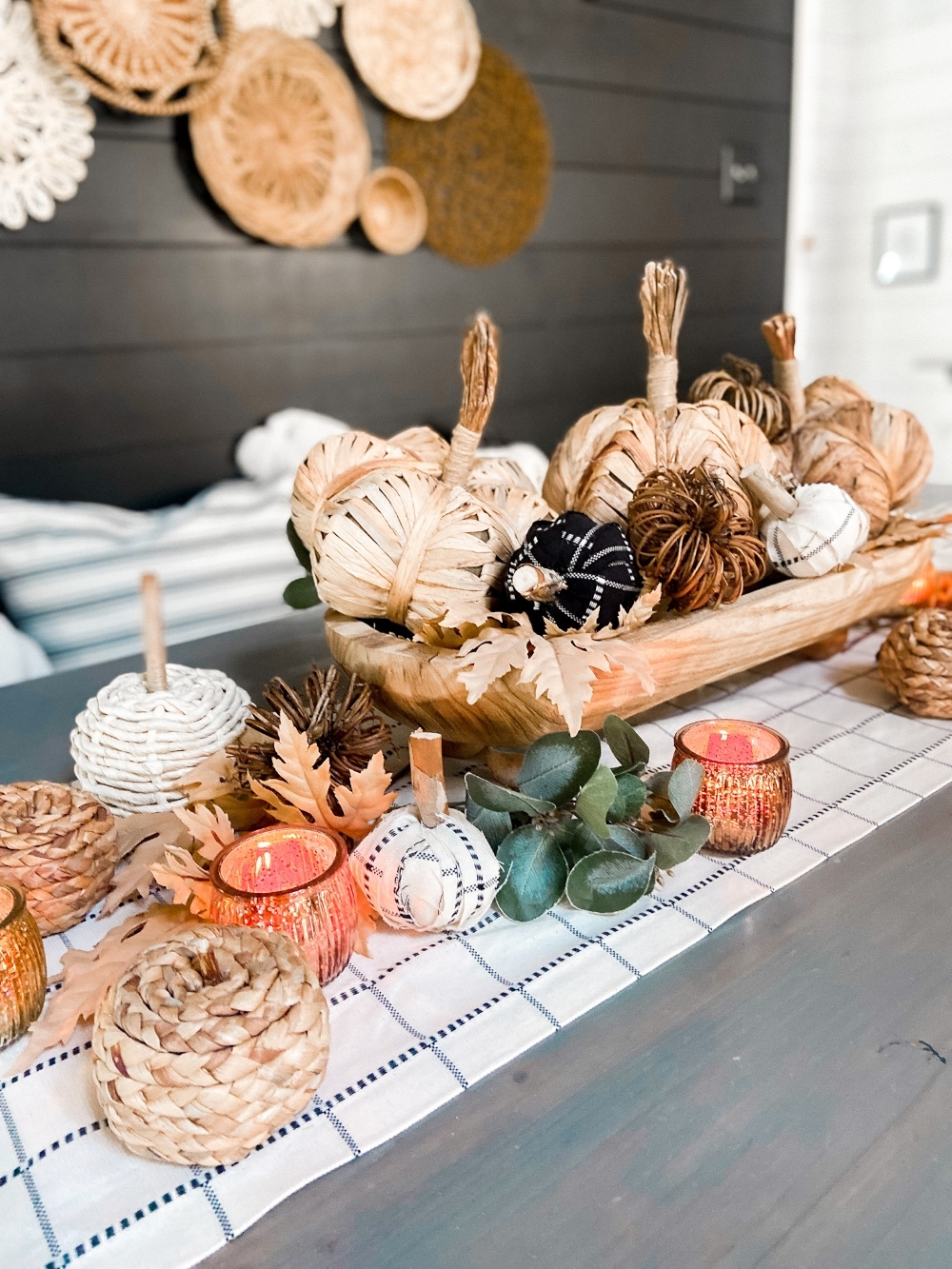 Boho Cottage Fall Tablescape. Create a warm and inviting table by making a DIY table runner, pillows and a beautiful footed bowl centerpiece filled with textured, fabric-covered pumpkins and leaves.