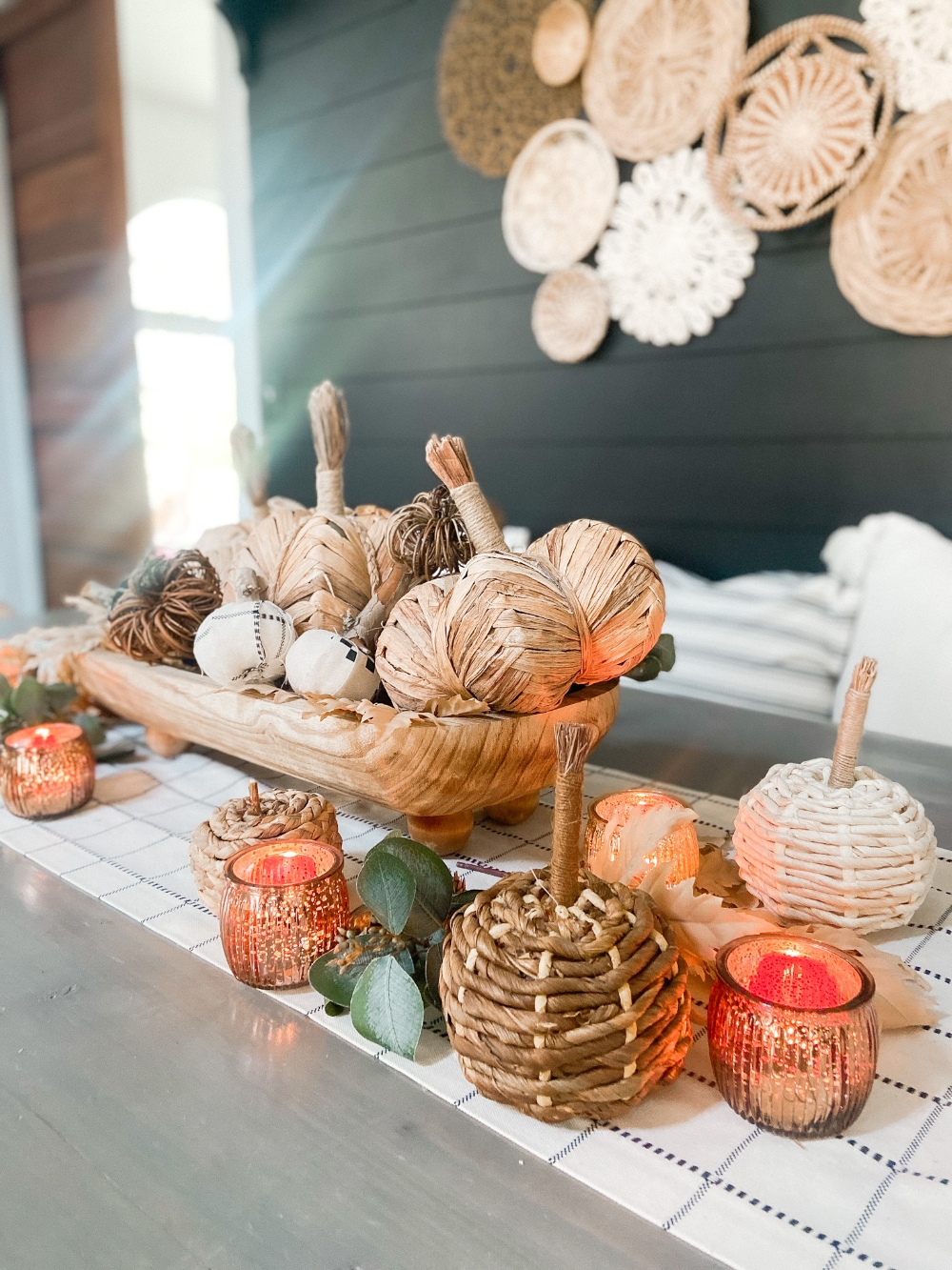 Boho Cottage Fall Tablescape. Create a warm and inviting table by making a DIY table runner, pillows and a beautiful footed bowl centerpiece filled with textured, fabric-covered pumpkins and leaves.