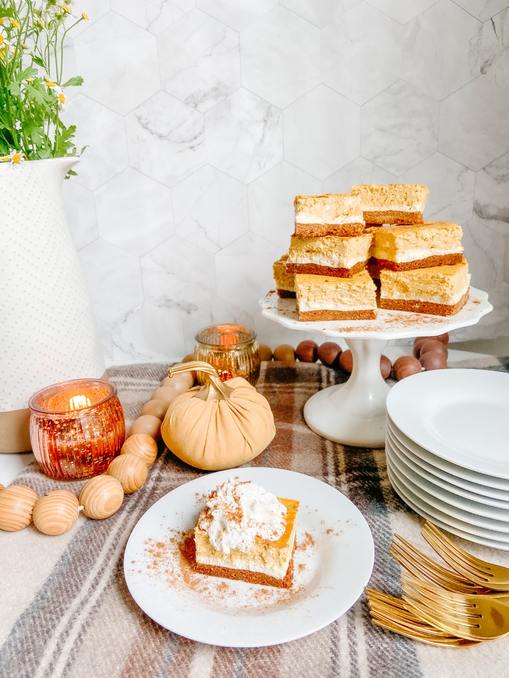 Triple Layer Pumpkin Cheesecake Bars. Creamy layers of cheesecake and pumpkin cheesecake with a ginger cinnamon crust for a low-carb treat perfect for Fall!