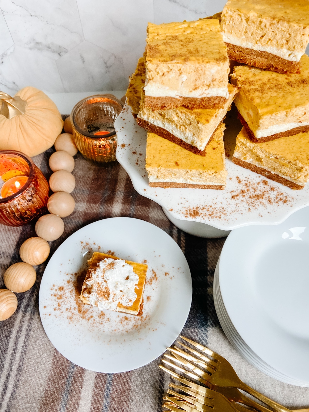 Triple Layer Pumpkin Cheesecake Bars. Creamy layers of cheesecake and pumpkin cheesecake with a ginger cinnamon crust for a low-carb treat perfect for Fall!