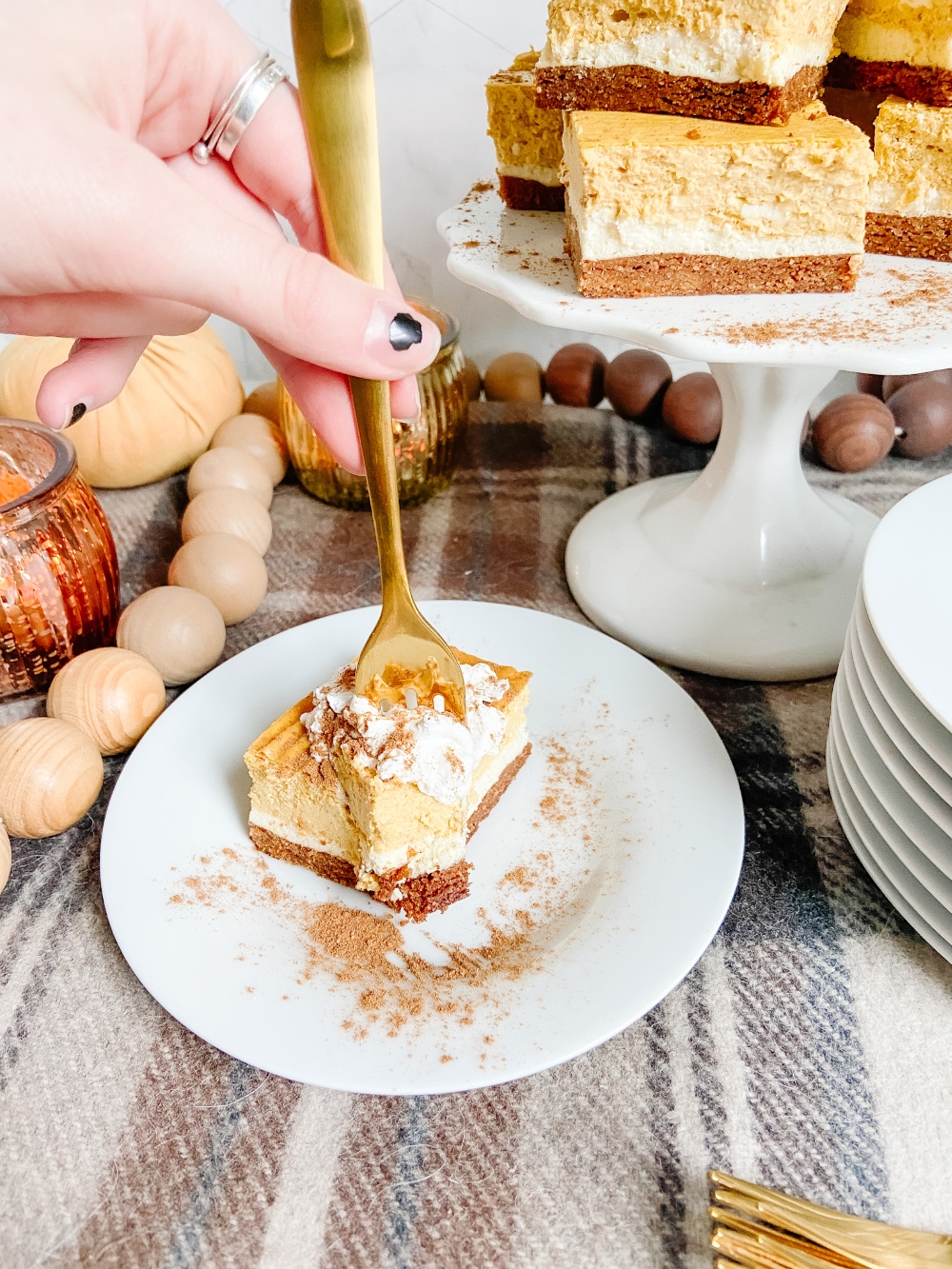 Triple Layer Pumpkin Cheesecake Bars. Creamy layers of cheesecake and pumpkin cheesecake with a ginger cinnamon crust for a low-carb treat perfect for Fall!