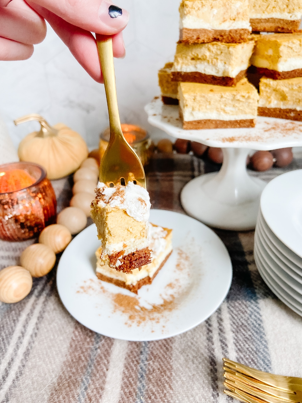 Triple Layer Pumpkin Cheesecake Bars. Creamy layers of cheesecake and pumpkin cheesecake with a ginger cinnamon crust for a low-carb treat perfect for Fall!