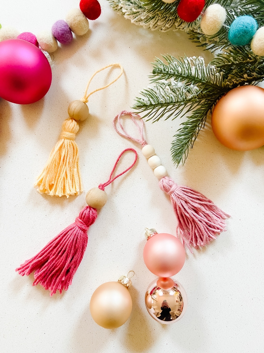 5-Minute Boho Tassel Ornaments. DIY Ornaments don't have to be complicated or expensive. All you need is yarn and beads! 