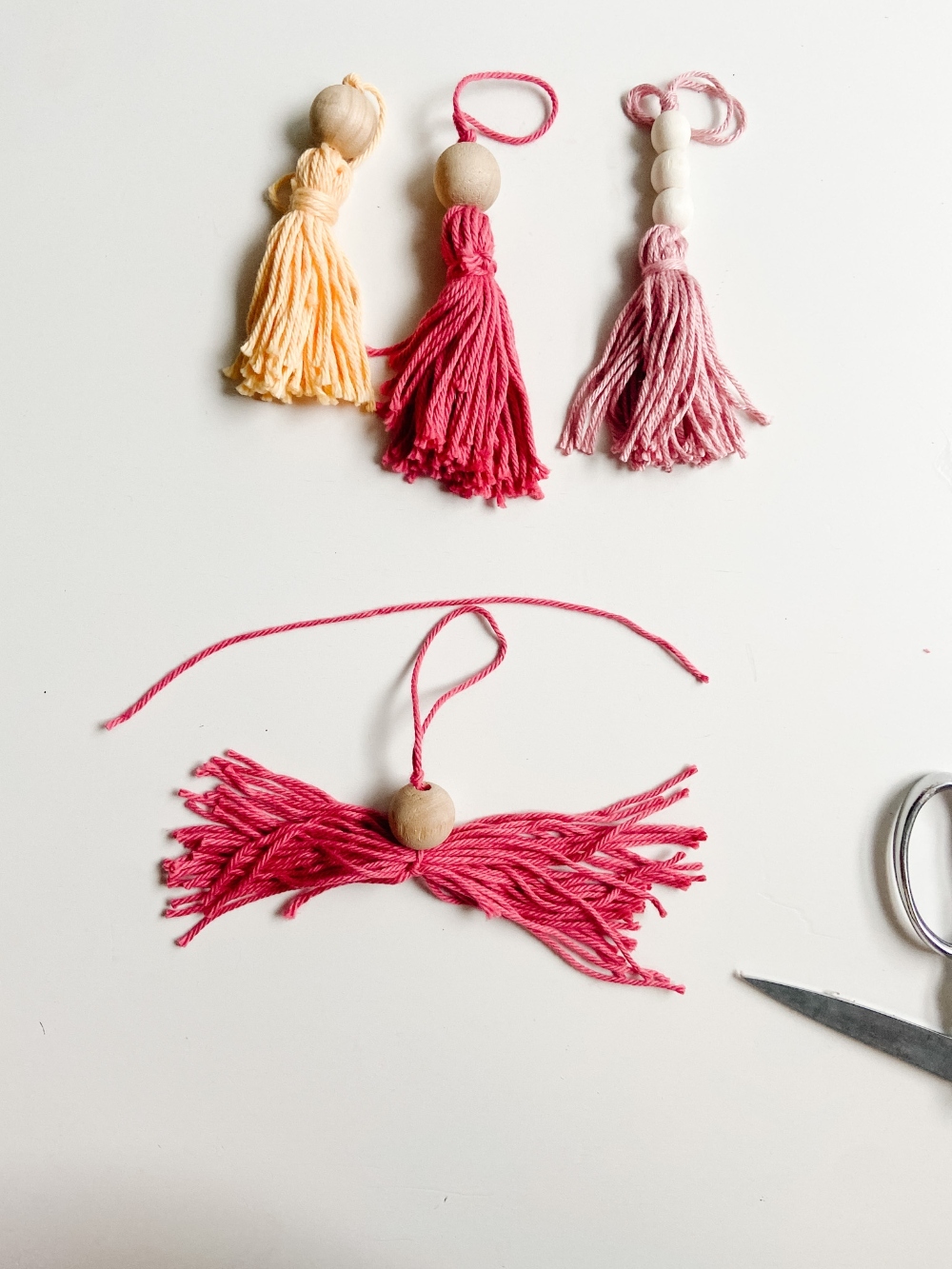 5-Minute Boho Tassel Ornaments. DIY Ornaments don't have to be complicated or expensive. All you need is yarn and beads! 