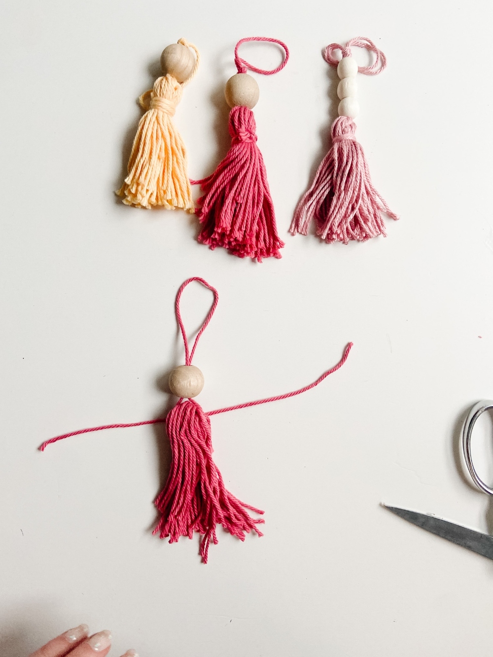 5-Minute Boho Tassel Ornaments. DIY Ornaments don't have to be complicated or expensive. All you need is yarn and beads! 