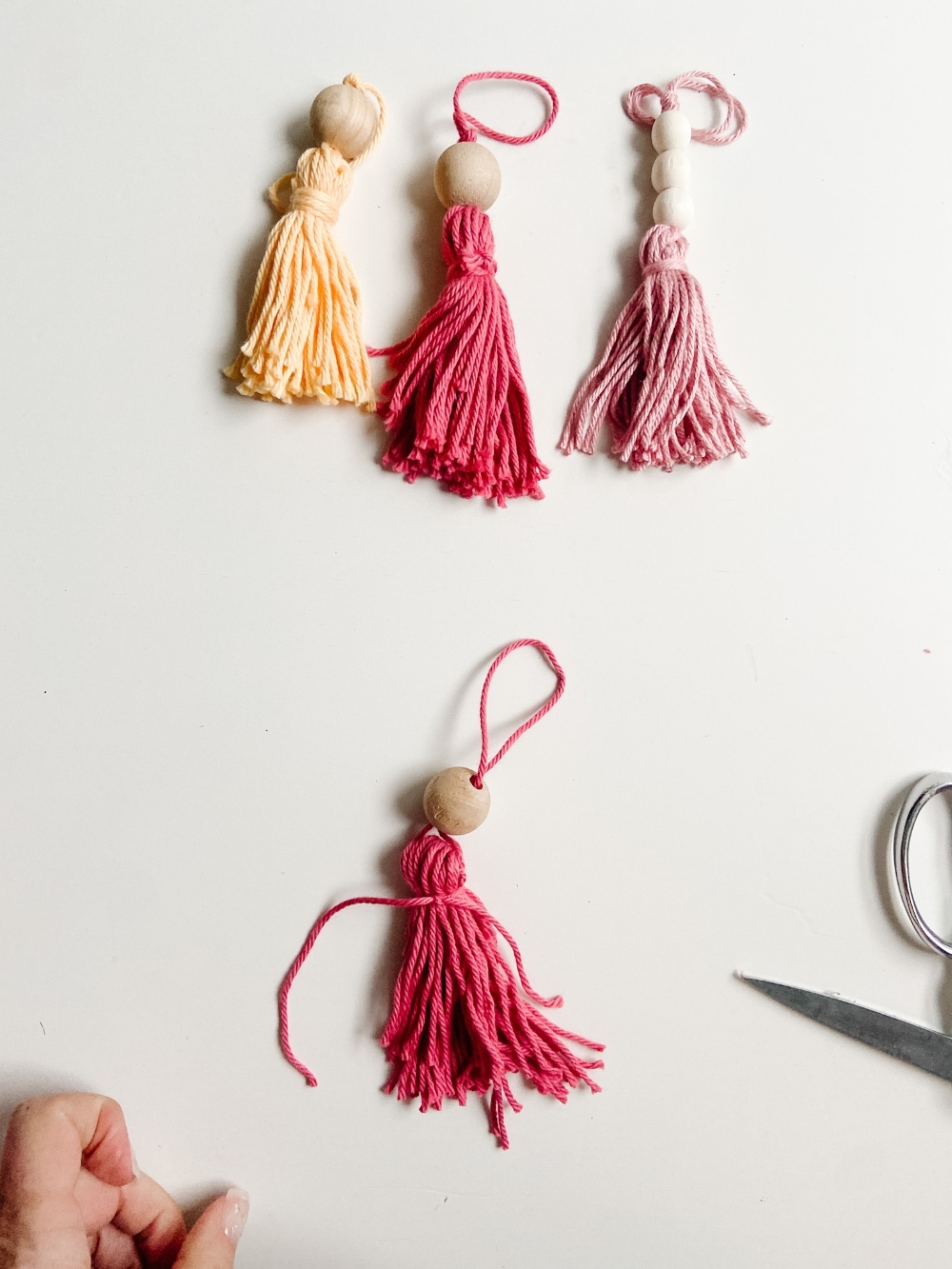 5-Minute Boho Tassel Ornaments. DIY Ornaments don't have to be complicated or expensive. All you need is yarn and beads! 