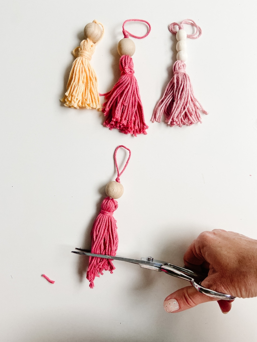 5-Minute Boho Tassel Ornaments. DIY Ornaments don't have to be complicated or expensive. All you need is yarn and beads! 