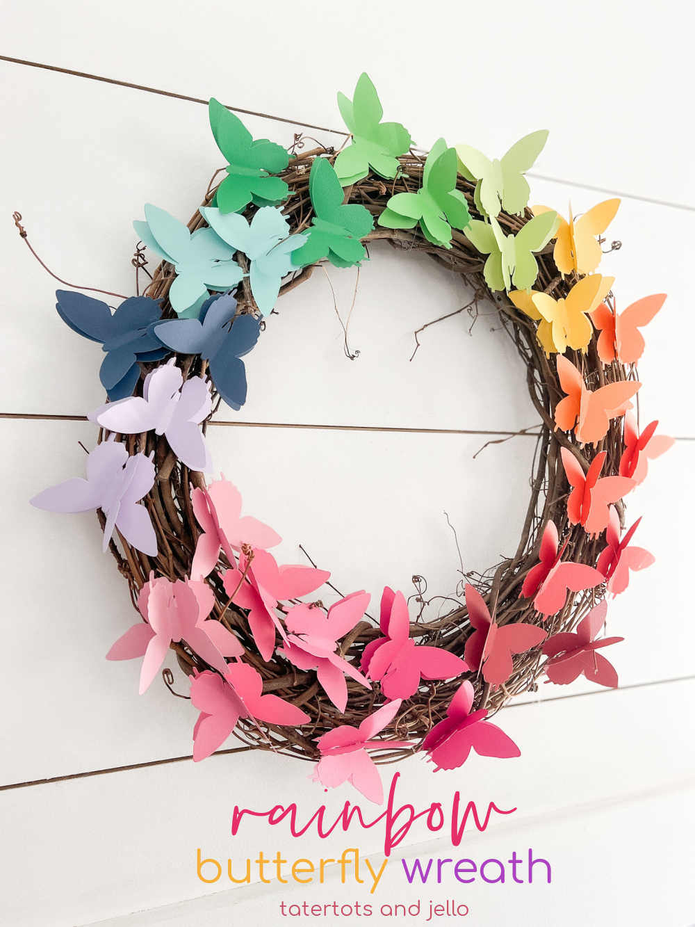 Easy Rainbow Butterfly Spring Wreath. Cut butterflies out of pretty paper for a happy rainbow wreath you can use all summer long! 