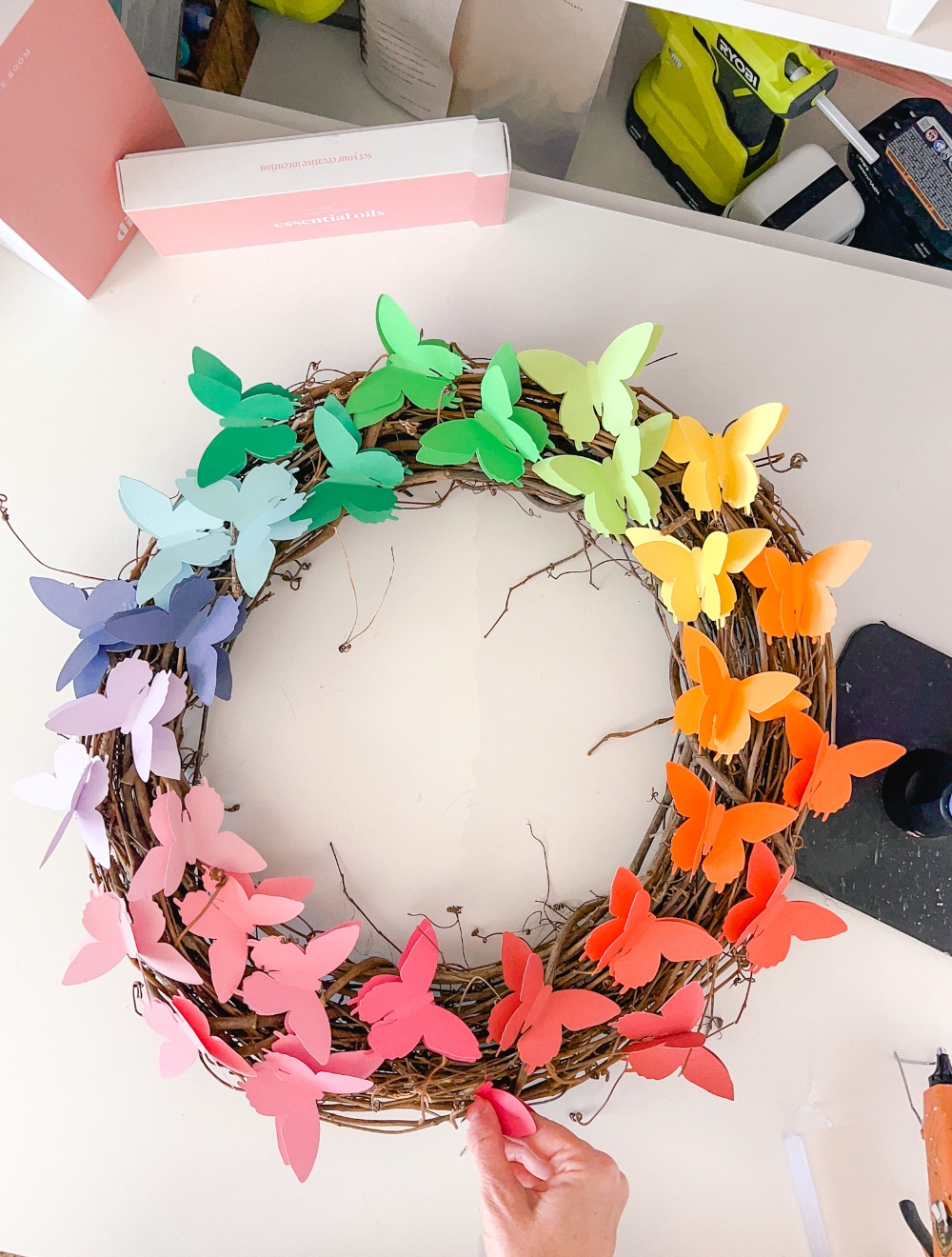 Easy Rainbow Butterfly Spring Wreath. Cut butterflies out of pretty paper for a happy rainbow wreath you can use all summer long! 