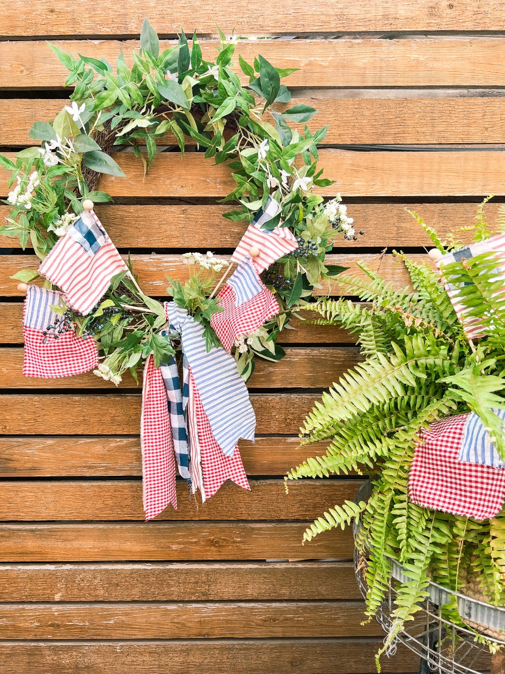 Easy Summer Fabric Flag Wreath. Create a fresh summer wreath with a patriotic twist with this green wreath with handmade fabric flags.