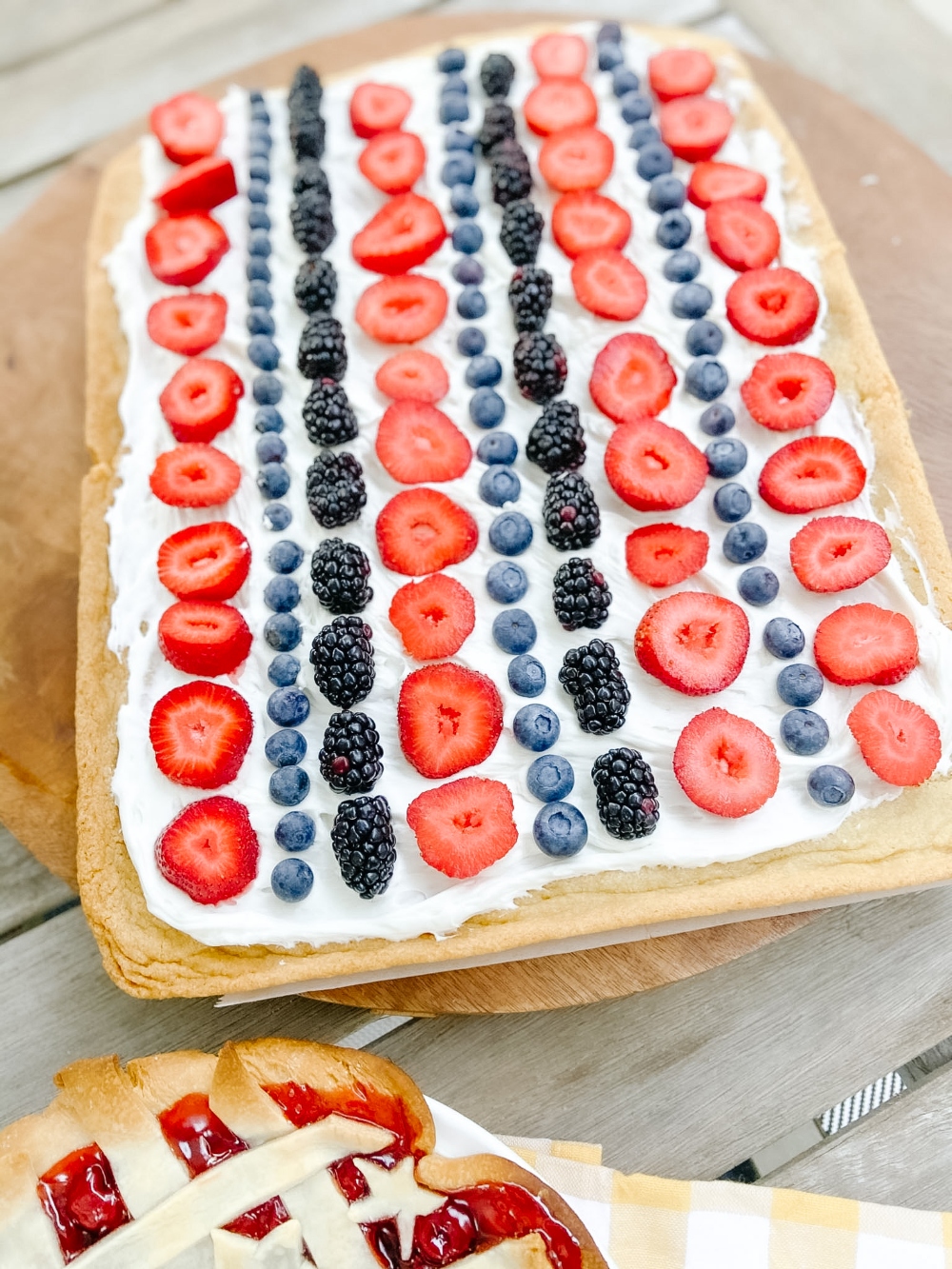 Patriotic Fruit Pizza Dessert. Chewy cookie crust is layered with light creamy topping and topped with fresh sweet berries for an easy semi-homemade summer dessert! 