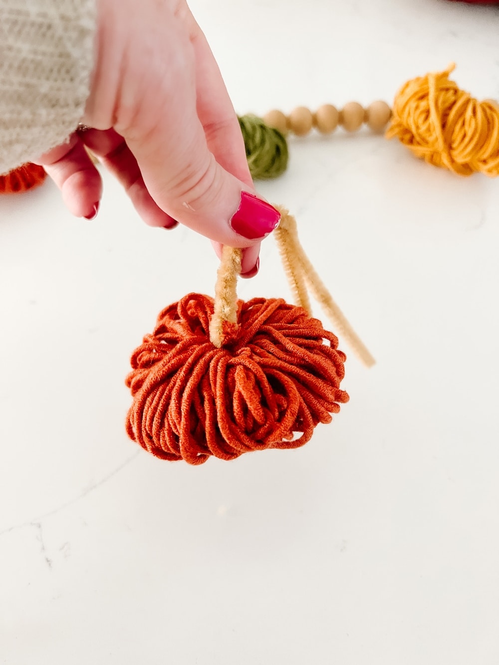 all Mantel and DIY Yarn Pumpkin Garland. Create a cozy layered mantel with a beautiful fall sign, foliage, vibrant fall pumpkins and A matching DIY yarn pumpkin garland! 