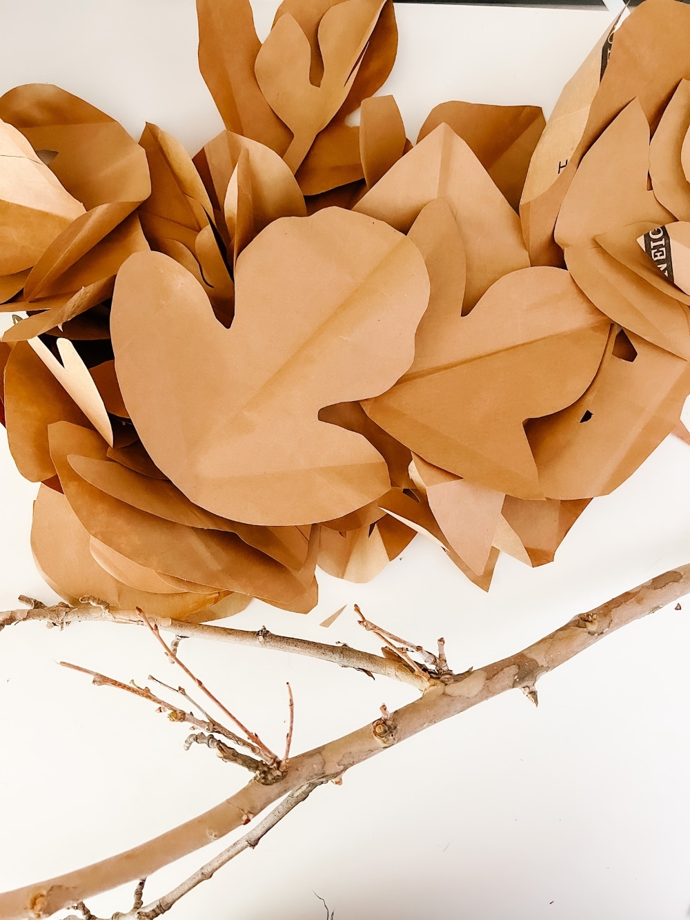 Paper Bag Leaf Garland. Upcycle your old paper grocery store bags into a warm and vibrant paper leaf garland for a mantel or shelf for Fall! 