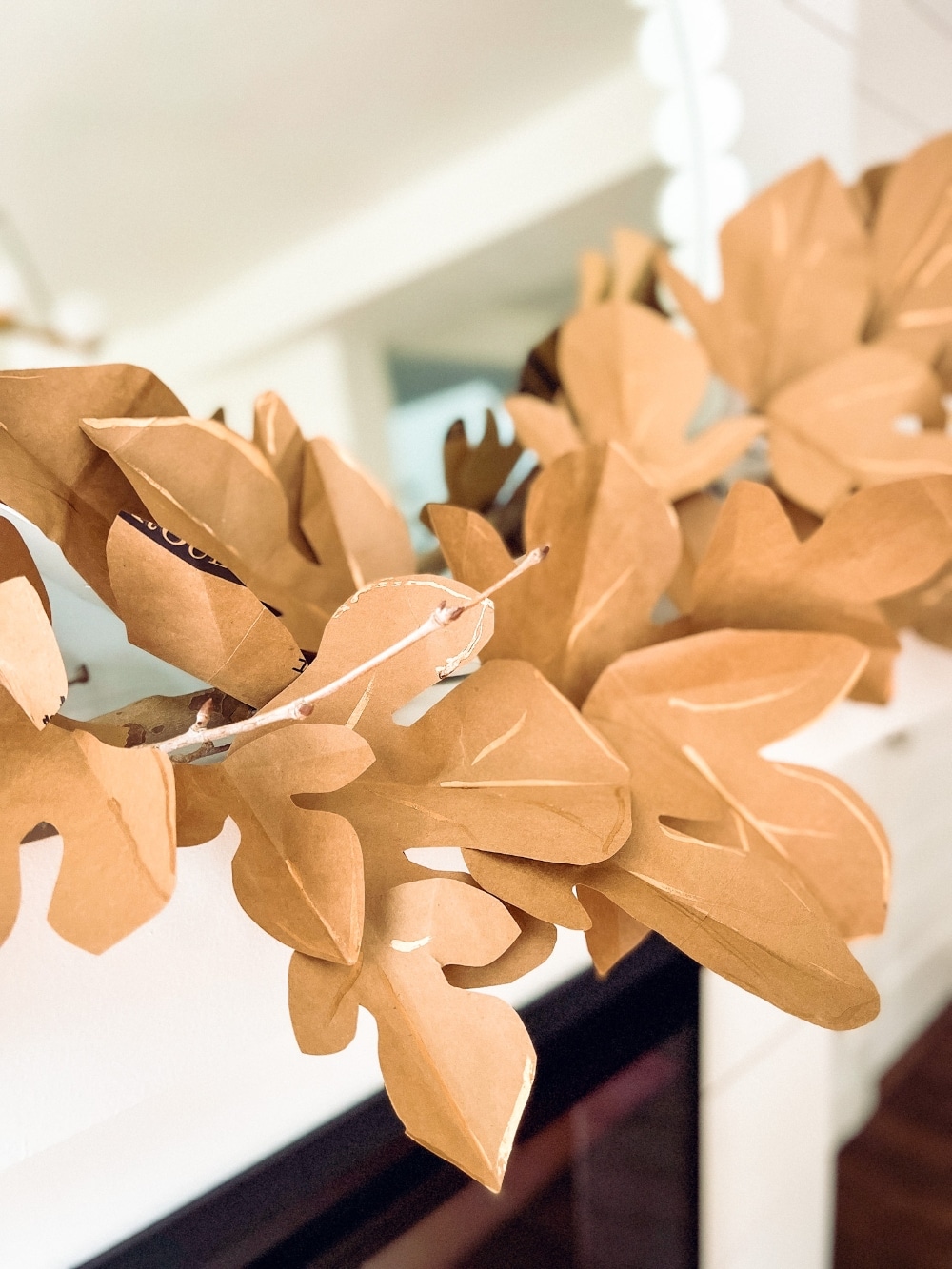 Paper Bag Leaf Garland. Upcycle your old paper grocery store bags into a warm and vibrant paper leaf garland for a mantel or shelf for Fall! 