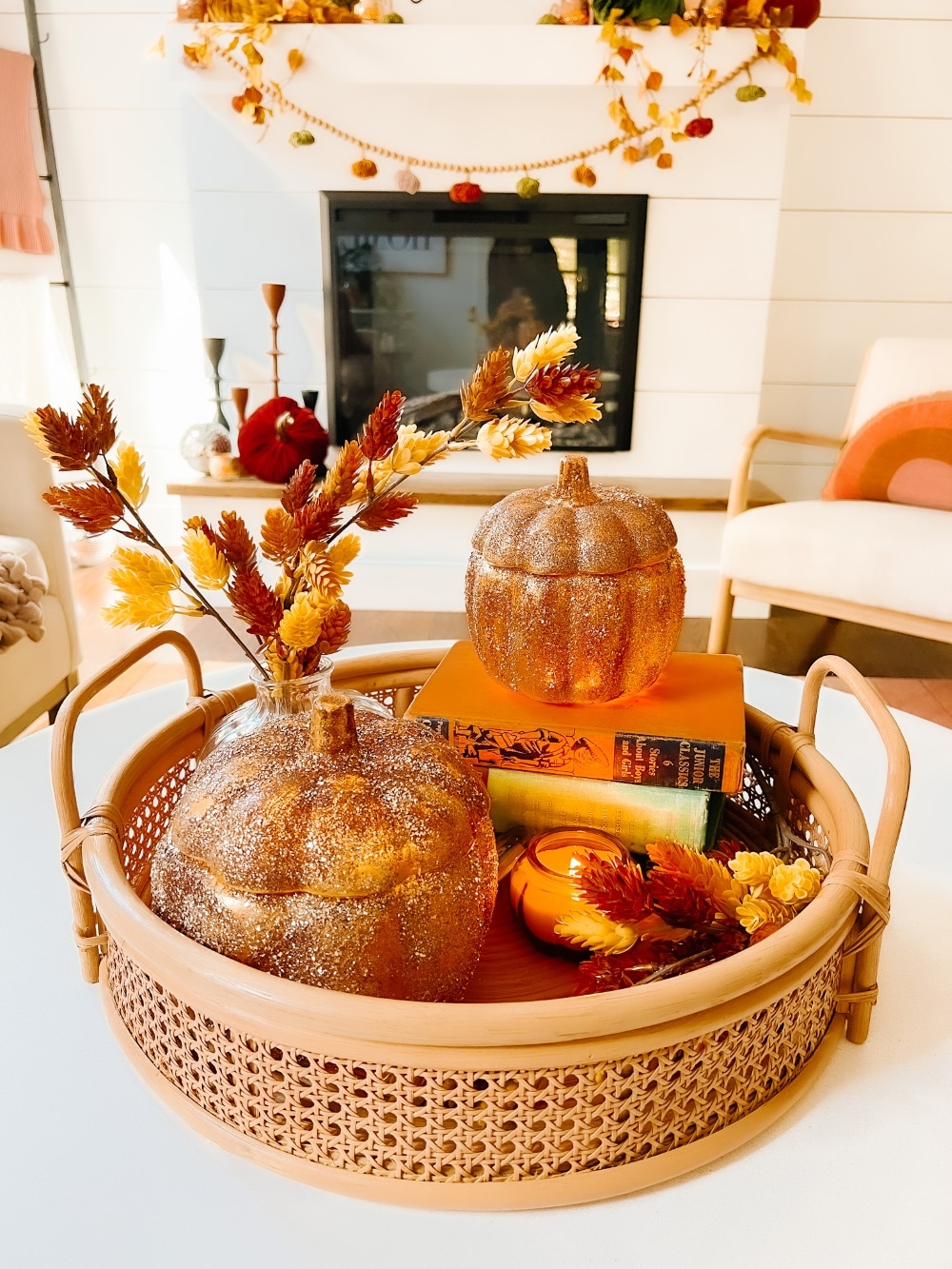 Pottery Barn Inspired Amber Pumpkin Cloches. Turn inexpensive glass pumpkin containers into high end looking cloches by painting and adding glitter! 