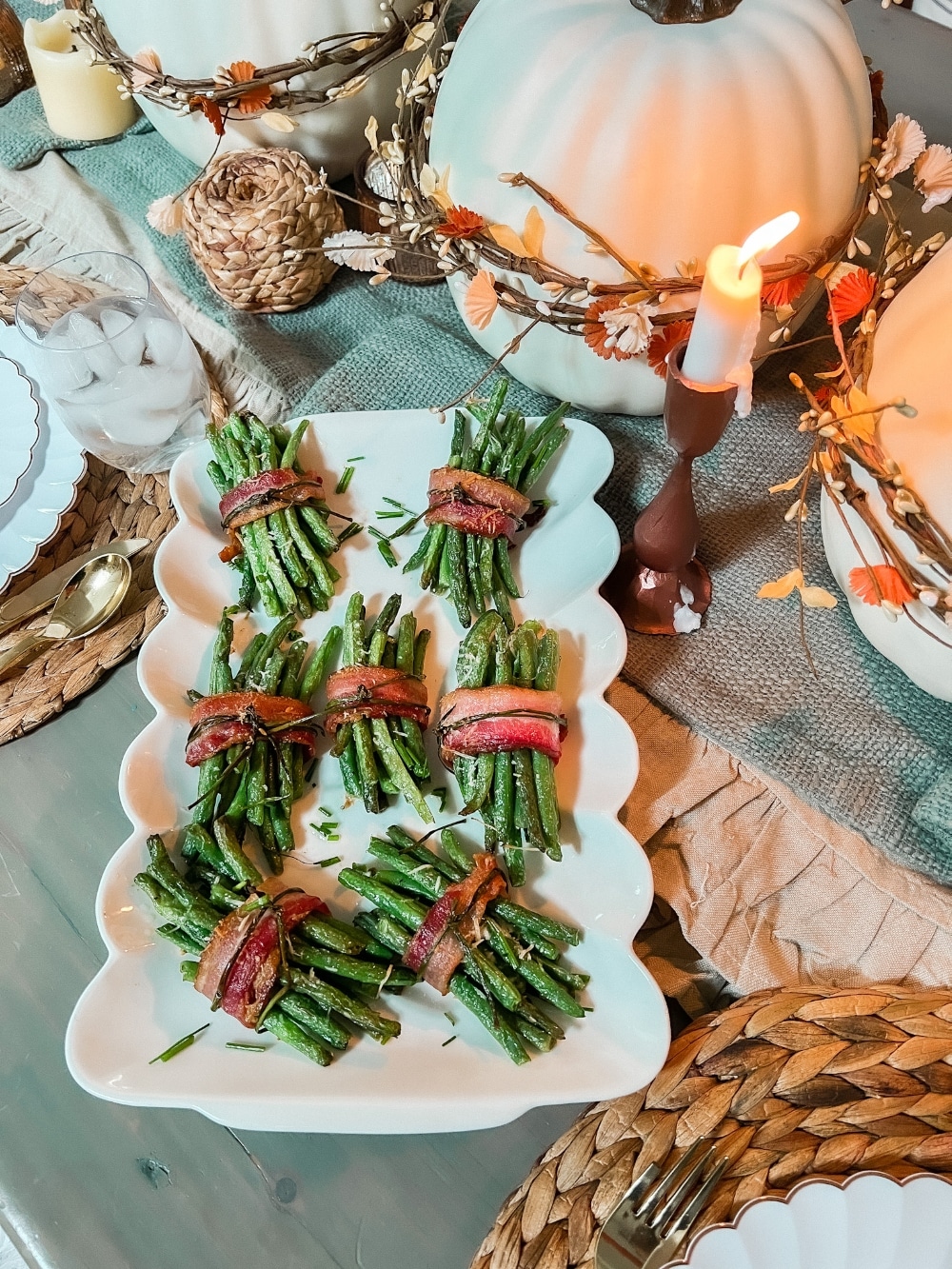 Bacon-Wrapped Green Bean Bundles. The perfect side dish for Thanksgiving or any holiday, these delicate green beans are layered with a garlic glaze and wrapped in crispy bacon with a chive bow. 