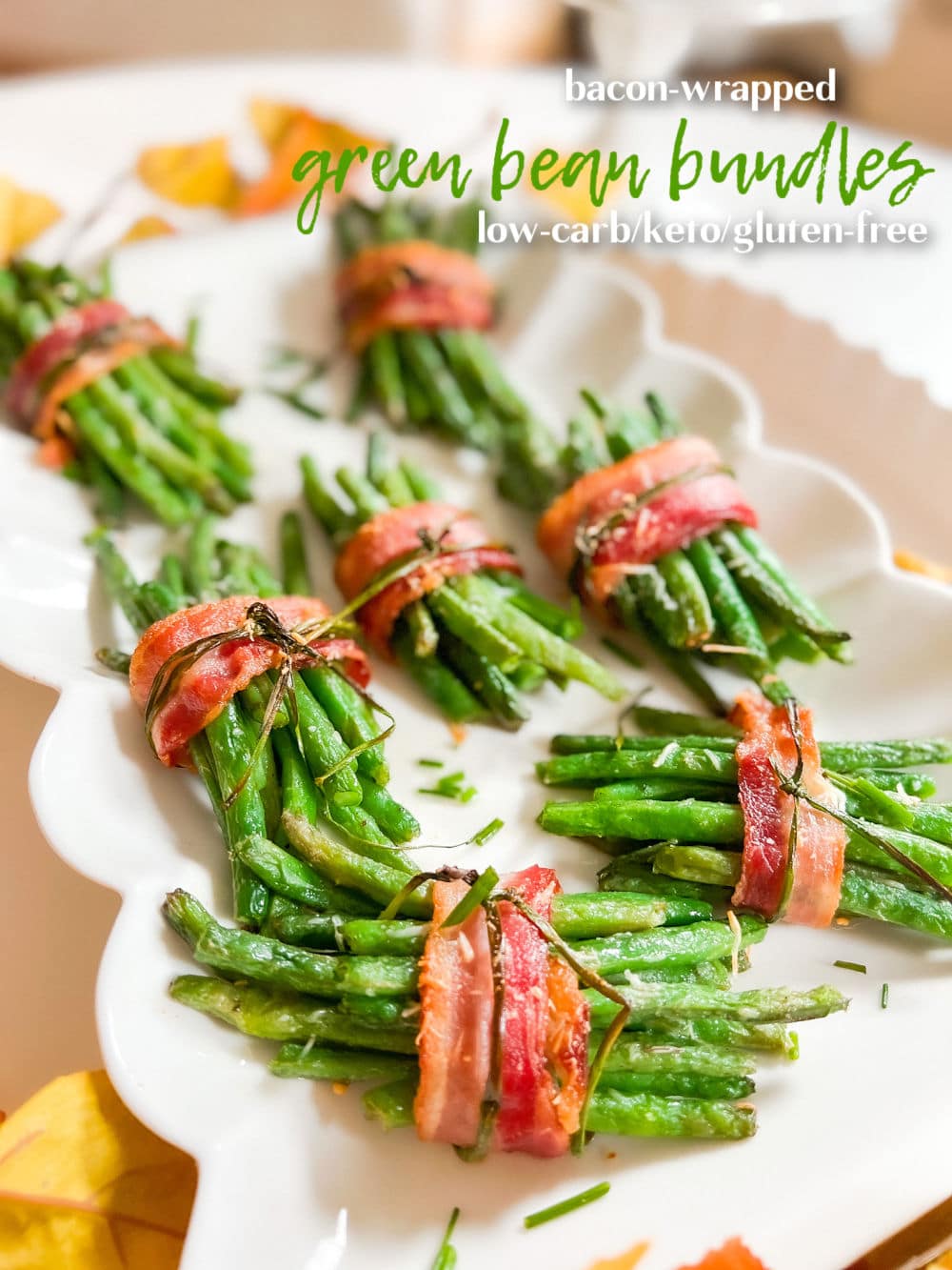 Bacon-Wrapped Green Bean Bundles. The perfect side dish for Thanksgiving or any holiday, these delicate green beans are layered with a garlic glaze and wrapped in crispy bacon with a chive bow. 