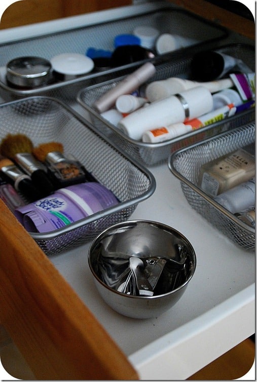 Use dollar store containers to get your bathroom drawers organized.