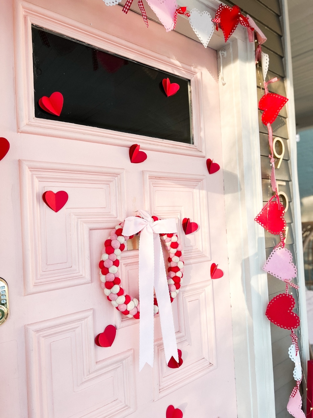 Easy DIY Valentine's Day Porch. Create a lovely Valentine porch with a homemade garland, painted signs, pillows and an easy DIY wreath. 