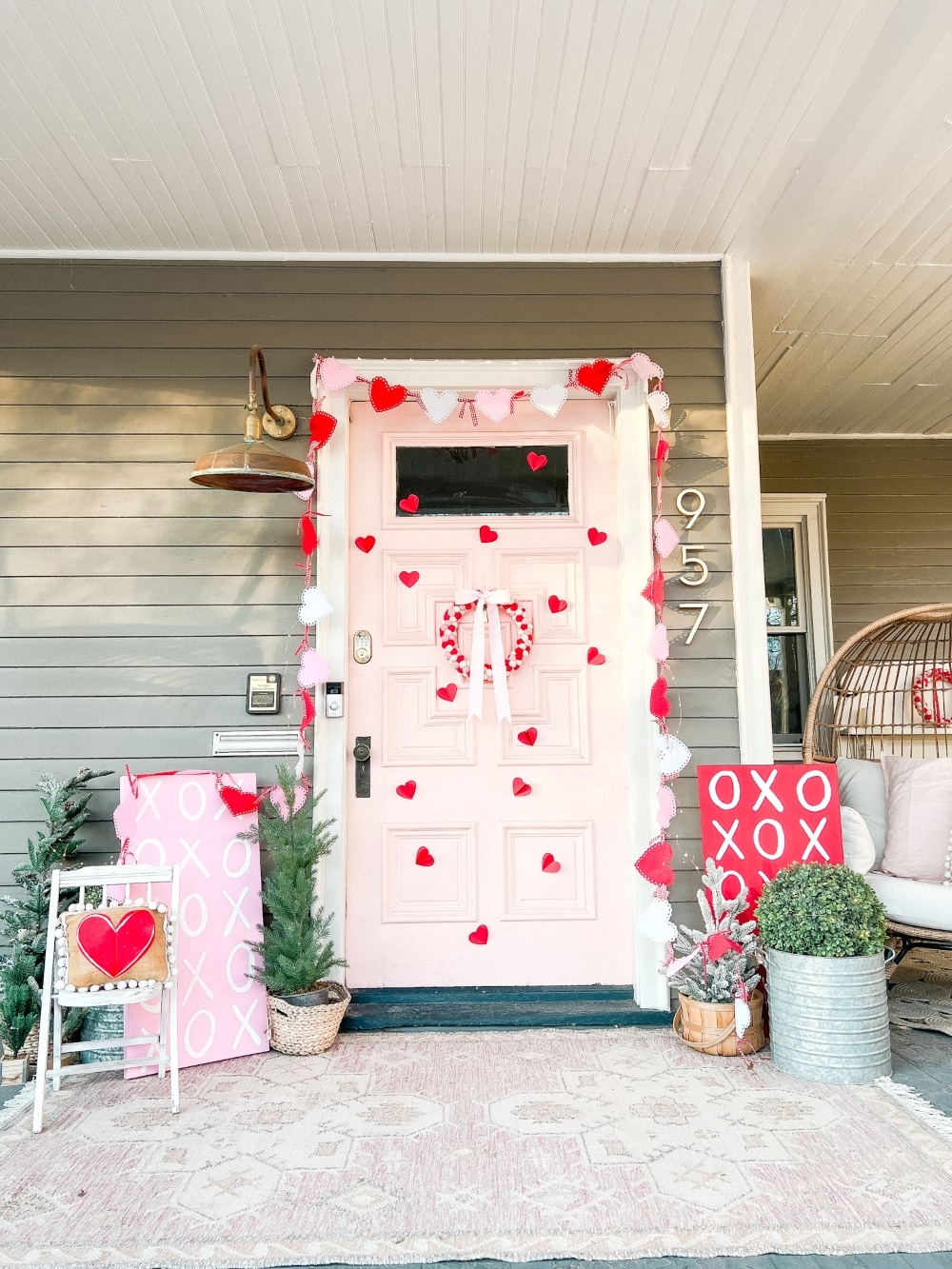 Easy DIY Valentine's Day Porch. Create a lovely Valentine porch with a homemade garland, painted signs, pillows and an easy DIY wreath. 