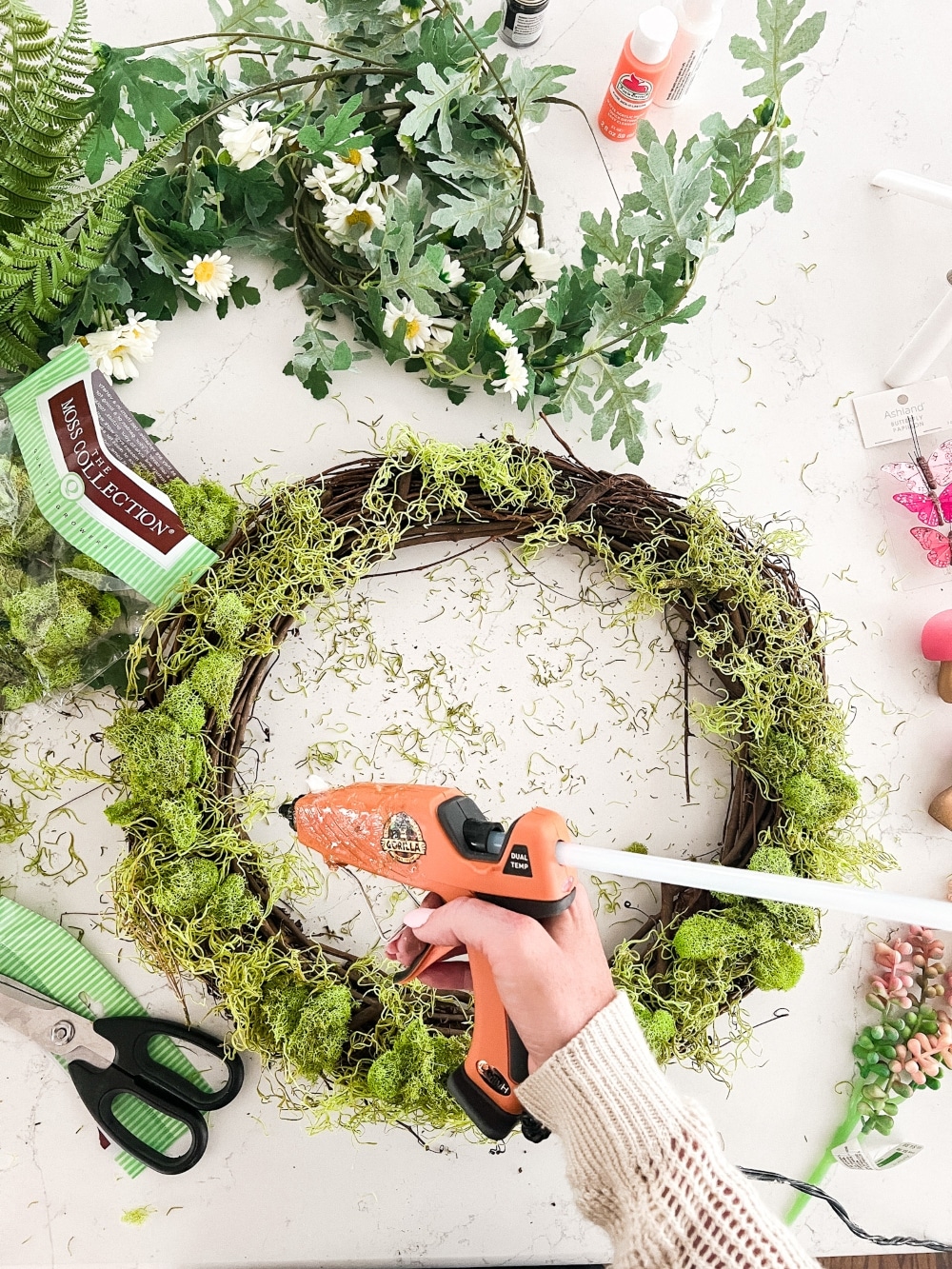 Spring Mushroom and Moss Wreath. Celebrate Spring by making this DIY wreath with wooden mushrooms, butterflies and moss!