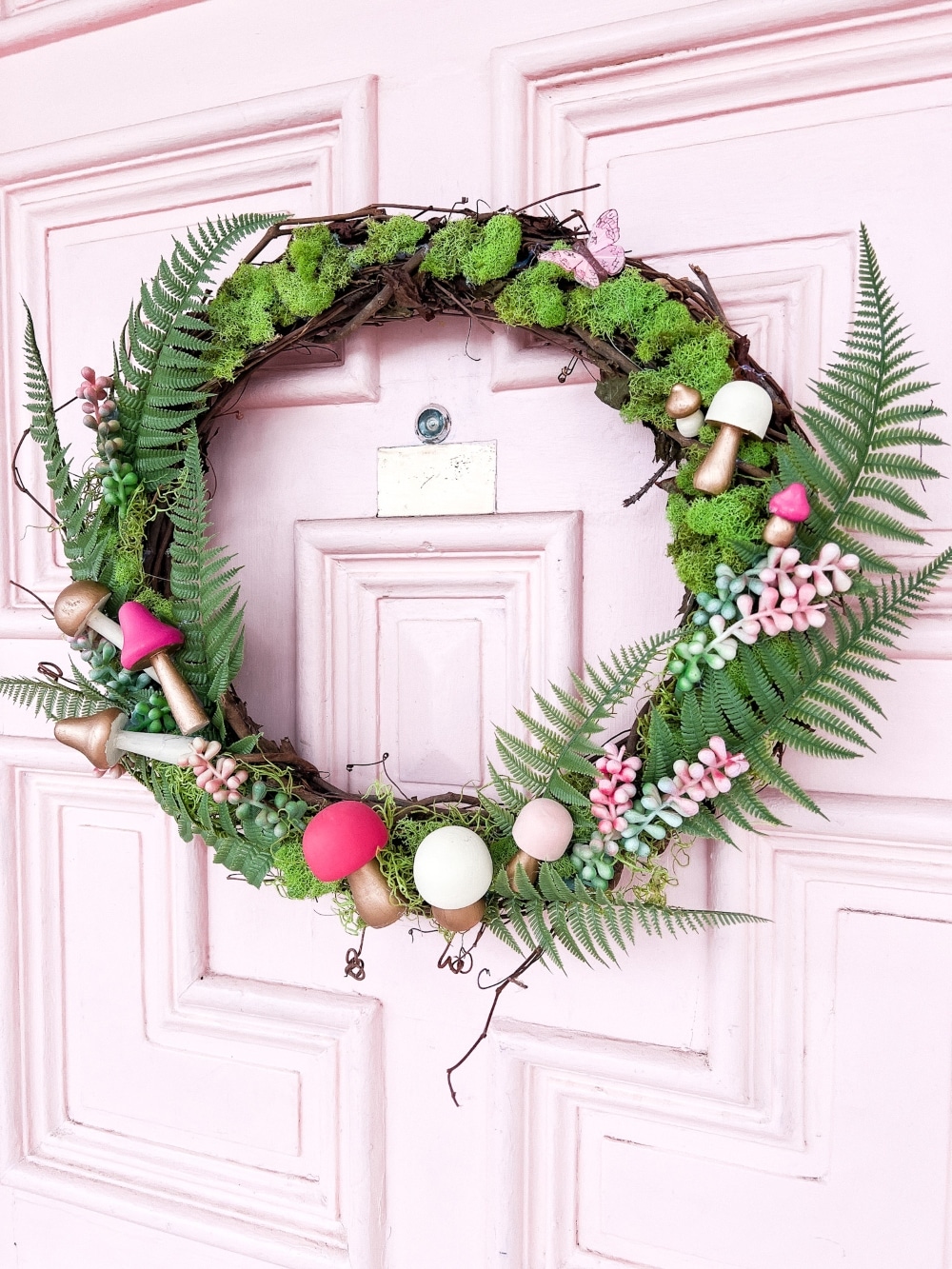 Spring Mushroom and Moss Wreath. Celebrate Spring by making this DIY wreath with wooden mushrooms, butterflies and moss!