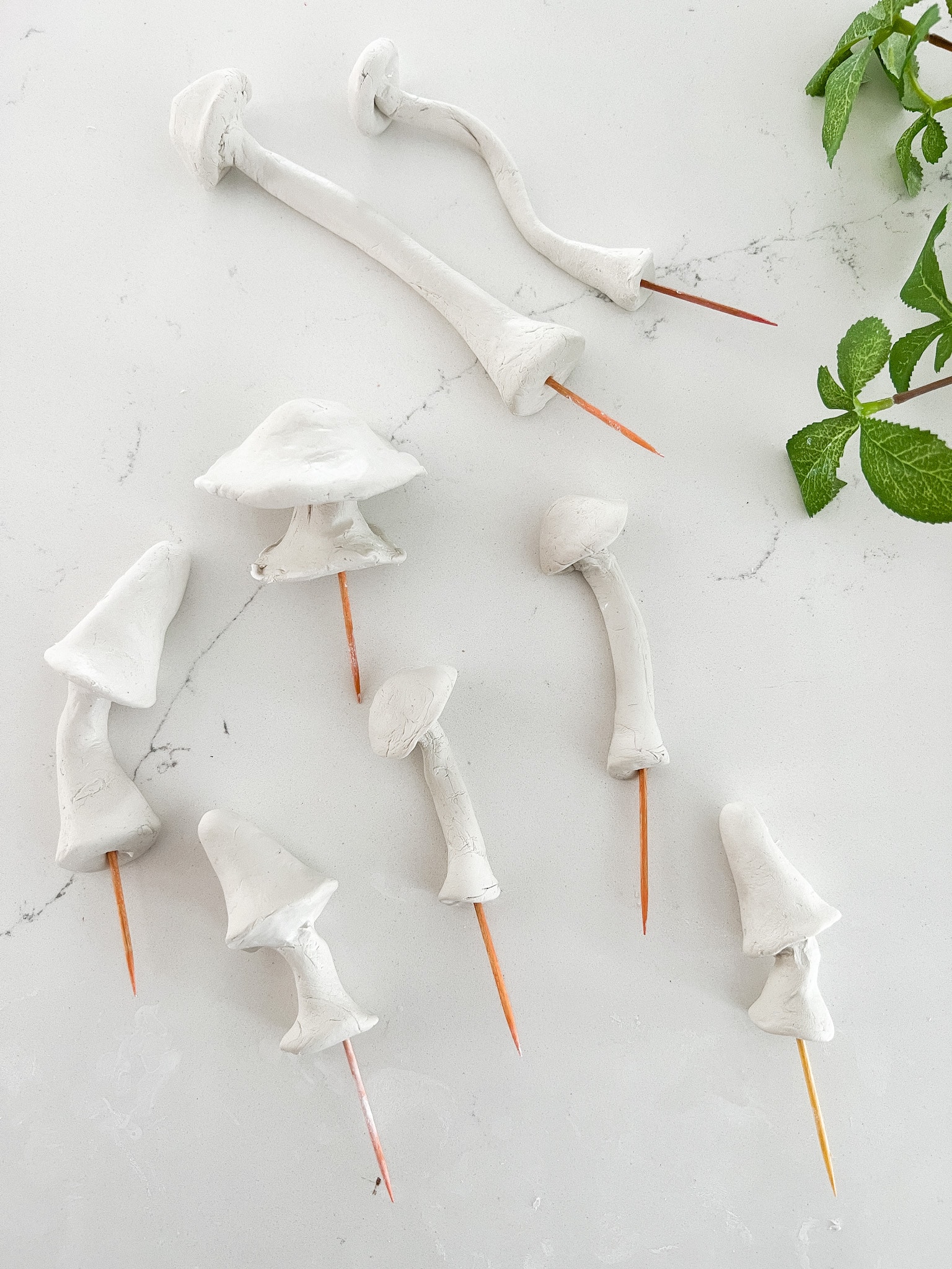 Anthropologie-Inspired Clay Mushroom Plant Stakes. Make these adorable clay mushroom stakes to add to planters and for Spring!