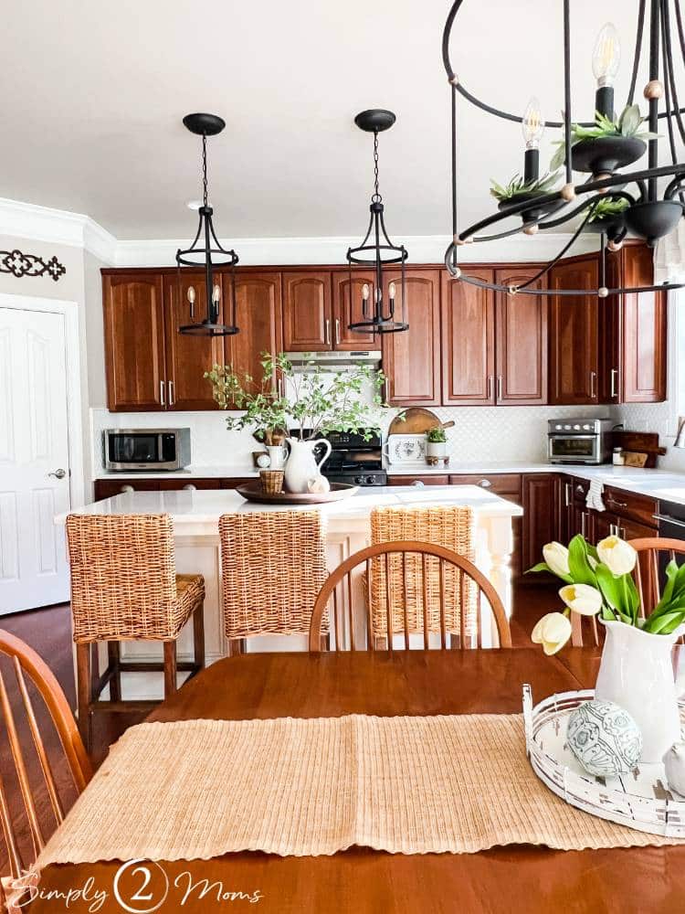 Who says a kitchen with cherry cabinets can’t look modern? We’ve got ideas to update your kitchen with wood cabinets without painting them!