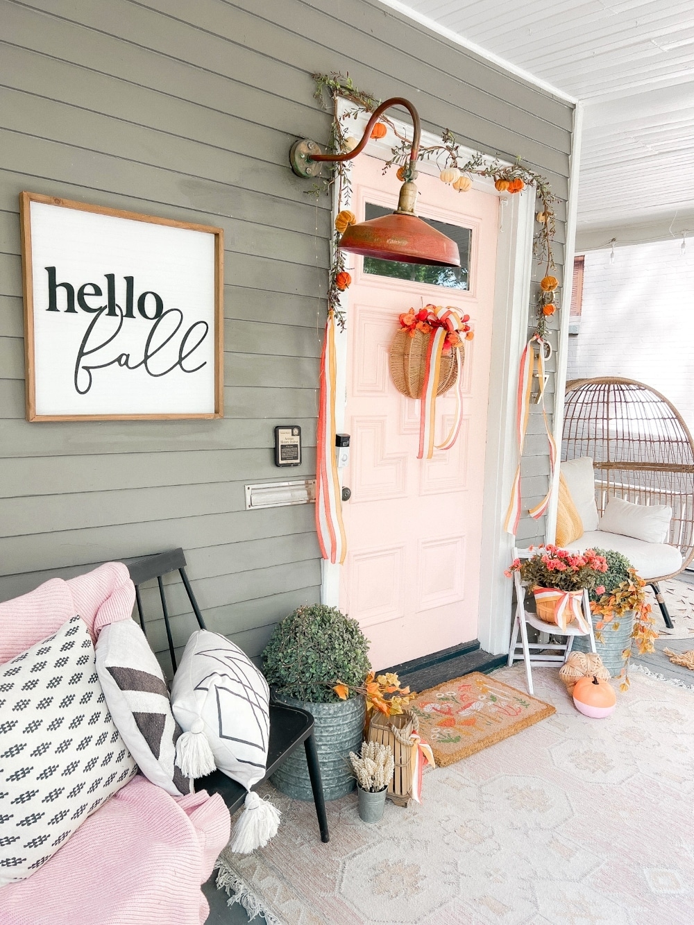 Embracing Autumn's Warmth: A Delightful Porch Transformation. Celebrate the crisp Fall season by incorporating a few simple items to transform your porch into a cozy Autumn haven. 