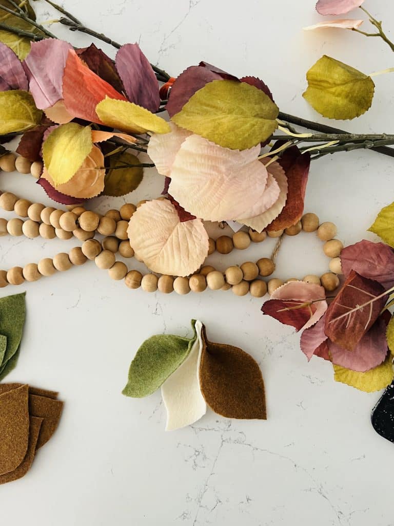 DIY Fall Felt Leaves Beaded Garland. Bring the beautiful of fall into your home with this colorful felt leaf garland!