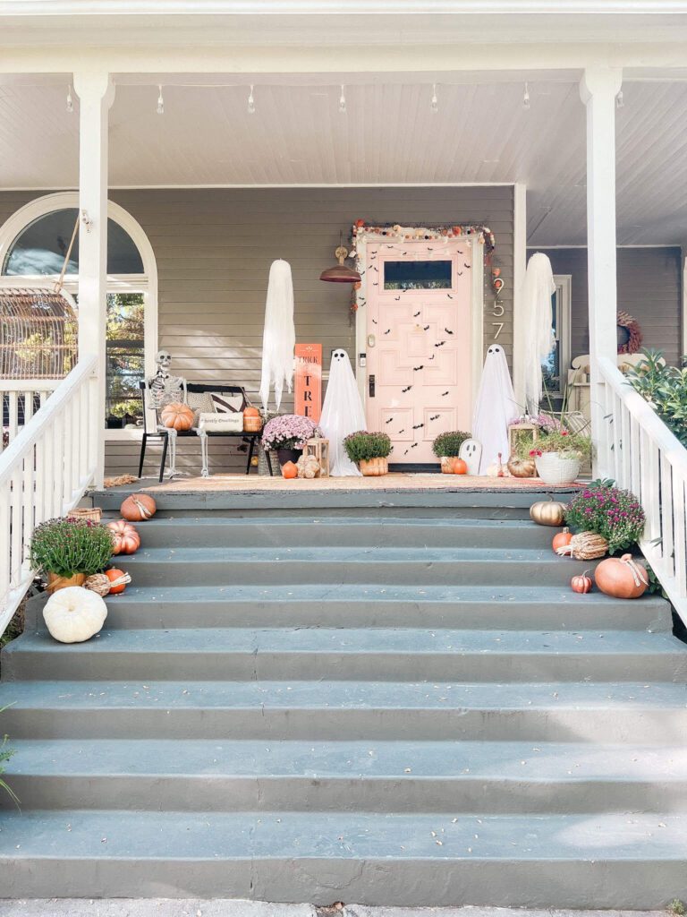 Ghost Porch: Create a spooky ghost porch by creating taall ghost luminaries with tomato cages, hanging light-up ghosts and aa hand-painted ghost doormat!