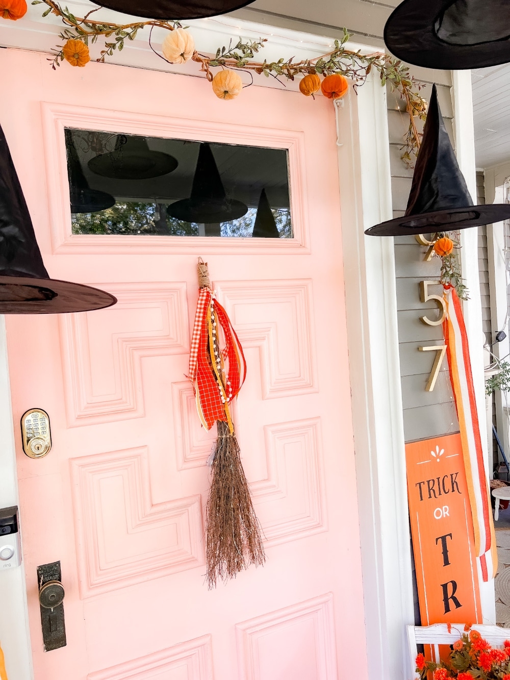 Halloween Witches Broom Wreath. Cast a welcoming spell on visitors this Halloween by creating a delightful witch porch. A glowing witches broom is a whimsical wreath alternative. Battery operated shimmering lights will light the way for guests. This is a hack on the Pottery Barn version for a fraction of the price!