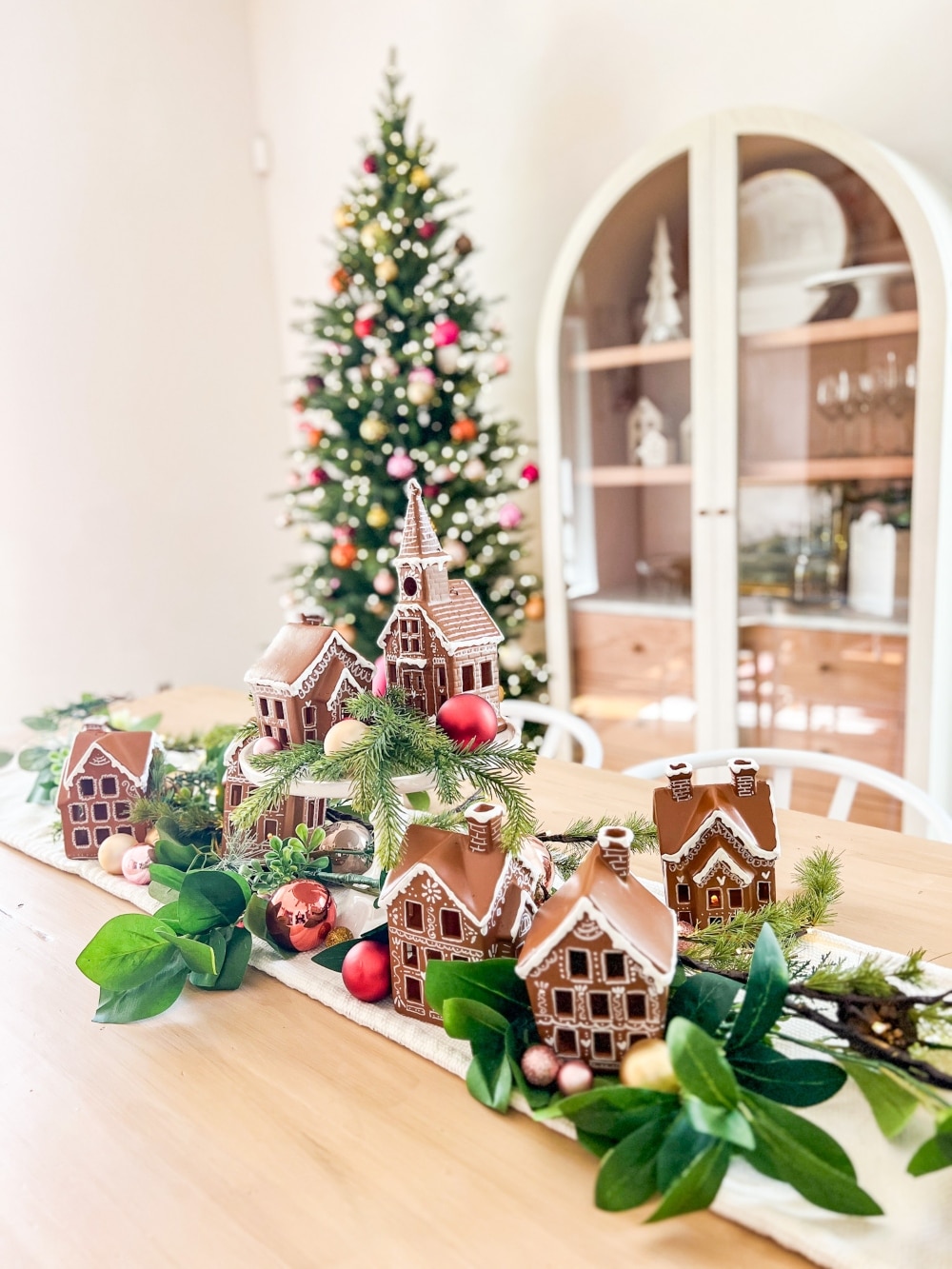 Turn a Ceramic Village into a Gingerbread Village. Revamp a plain ceramic Christmas village into a festive delight using spray paint, a white paint pen, and puffy paint. 