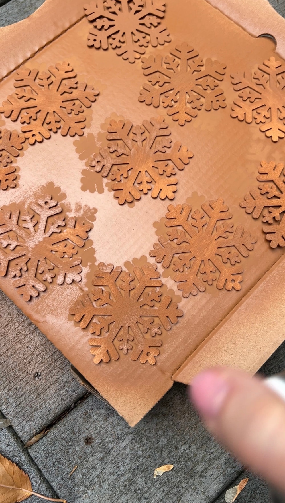 DIY Faux Gingerbread Cookie Ornaments. Transform simple wood snowflake ornaments into charming faux gingerbread cookies for a decoration that adds a touch of sugary sweetness to your holiday decor.