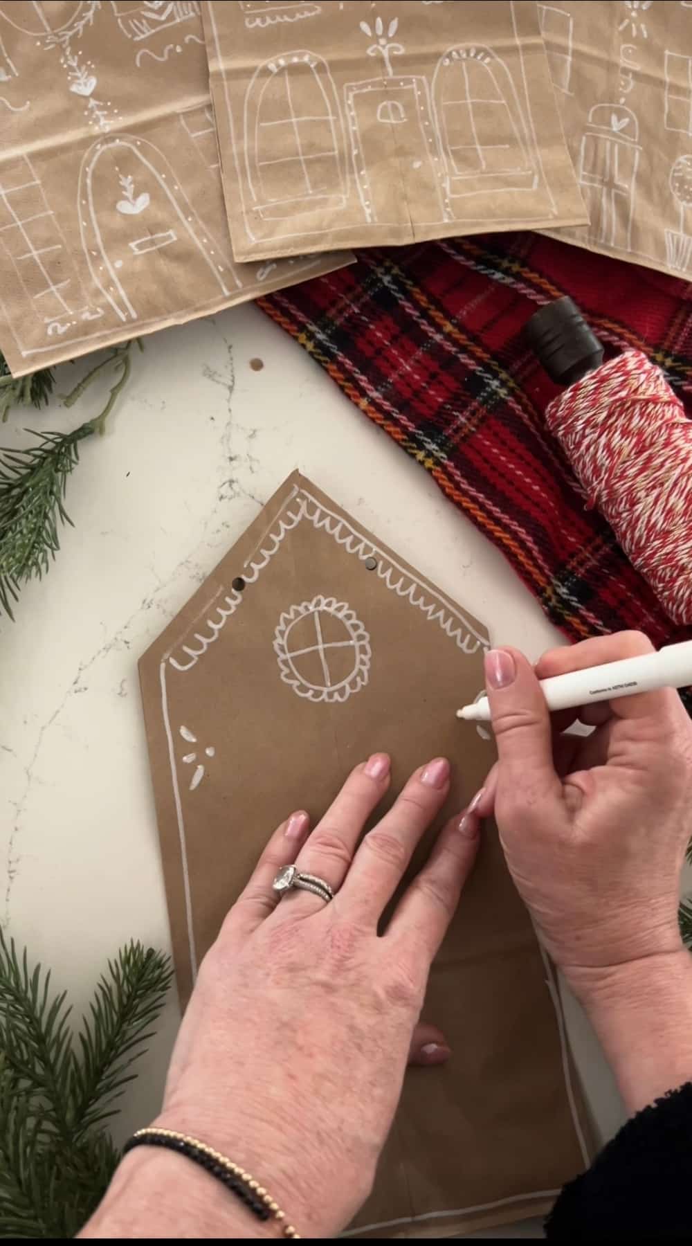 Make DIY Christmas Gingerbread Gift Bags. Transform plain paper bags into festive gingerbread house gift bags which are adorable under the tree or Christmas gatherings.