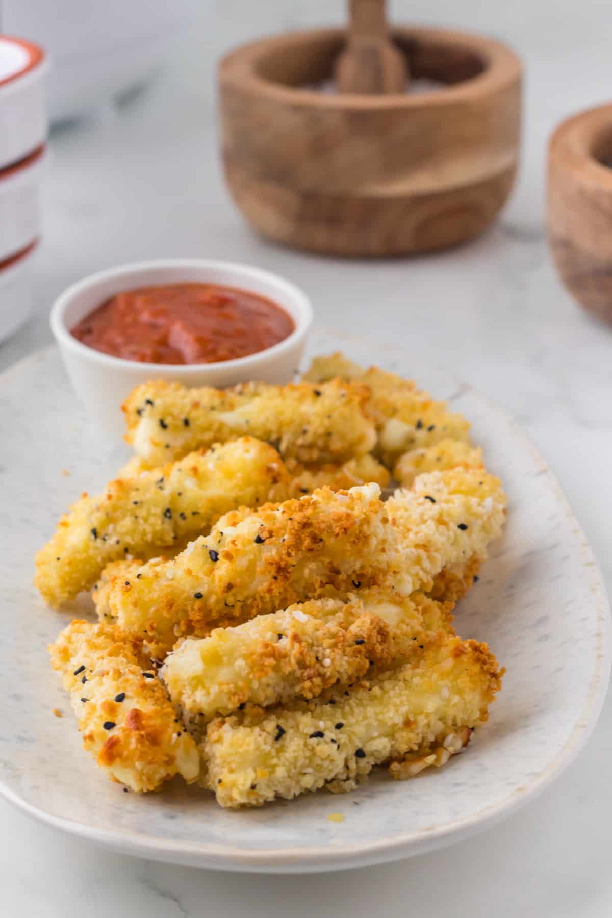 These easy Air Fryer Mozzarella Sticks are breaded mozzarella string cheese that are perfectly crispy on the outside and cheesy on the inside. Just as tasty as the deep fried version, without the extra calories and mess.