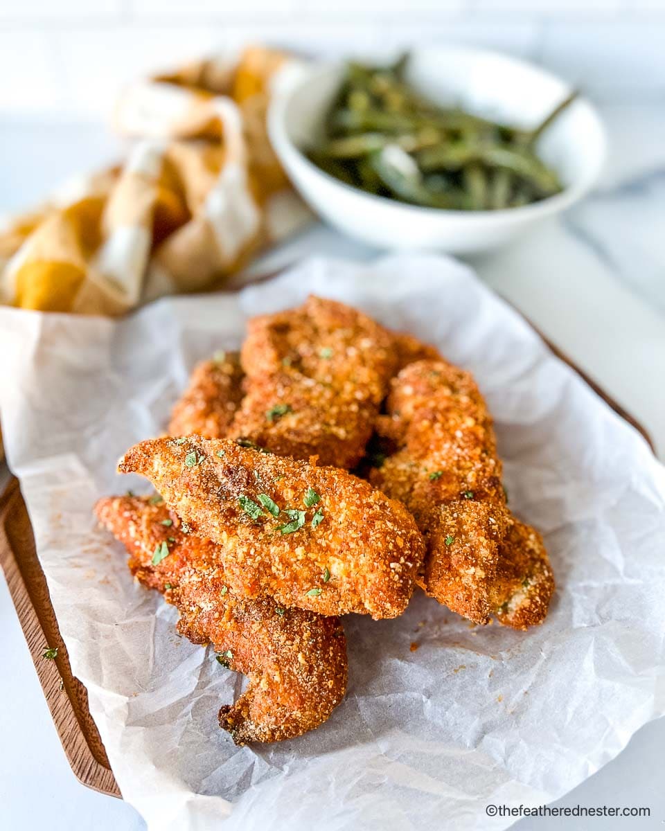 Learn how to bake juicy, extra crispy, breaded Shake and Bake chicken in the oven or air fryer for panko chicken tenders in 25 minutes!
