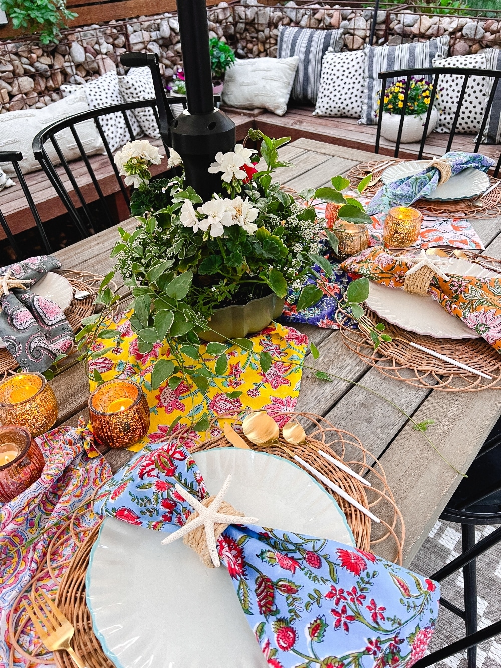 Colorful Nautical Spring Table. Create a vibrant coastal oasis with a Colorful Spring Nautical Table, featuring DIY napkin rings, woven placemats, candlelit ambiance, and lush green garland accents, perfect for unforgettable gatherings.