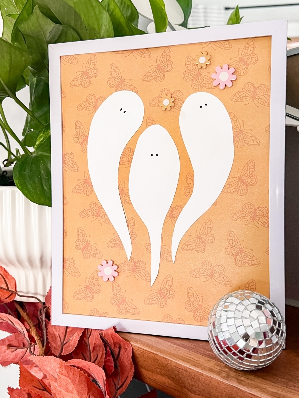 DIY Disco Halloween Art Using Scrapbook Paper. Create festive DIY disco-themed Halloween art using the scrapbook paper with these easy-to-follow steps for three spooky cute framed pieces.